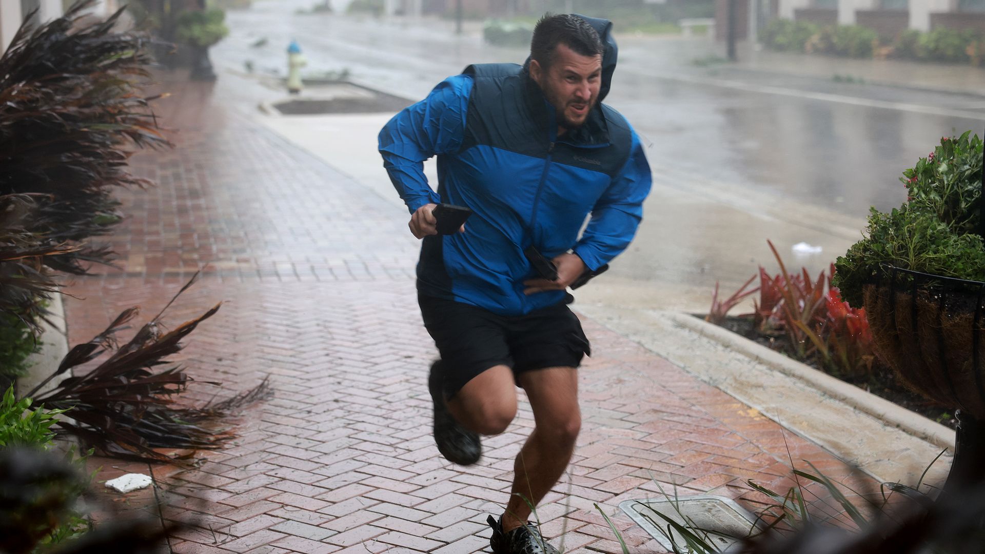 A man runs from stormy conditions.