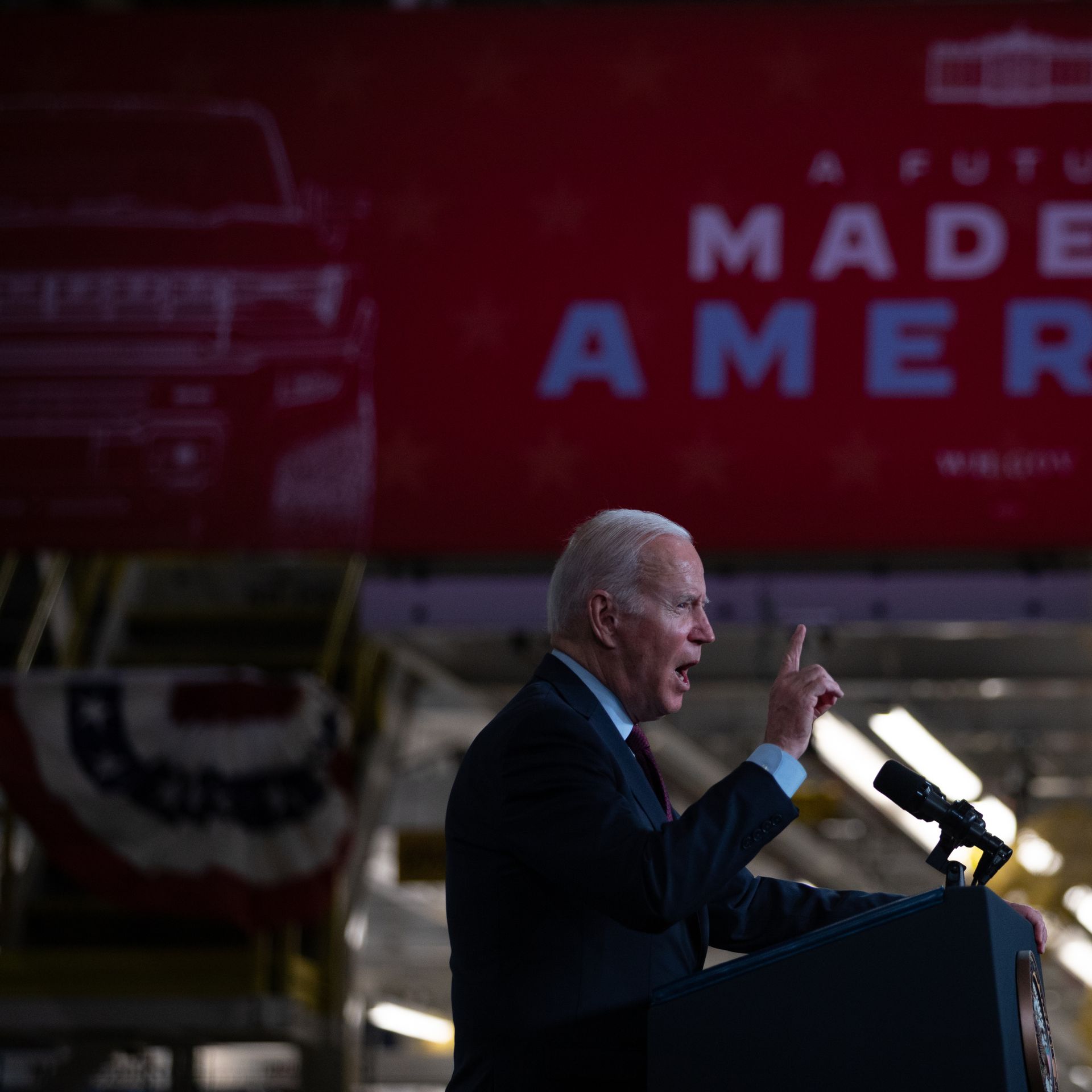 Biden waving his finger in front of a banner