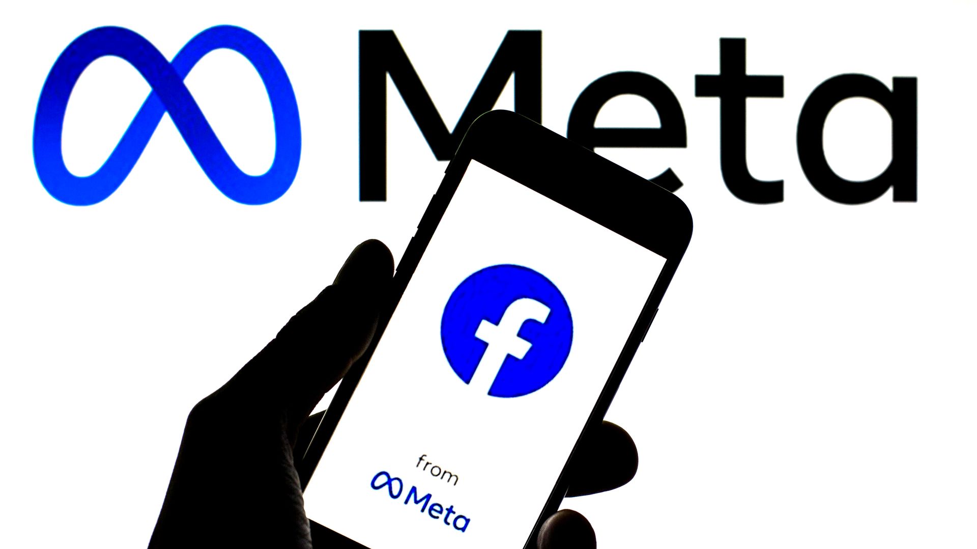 Image of Meta with Facebook app in foreground on mobile phone