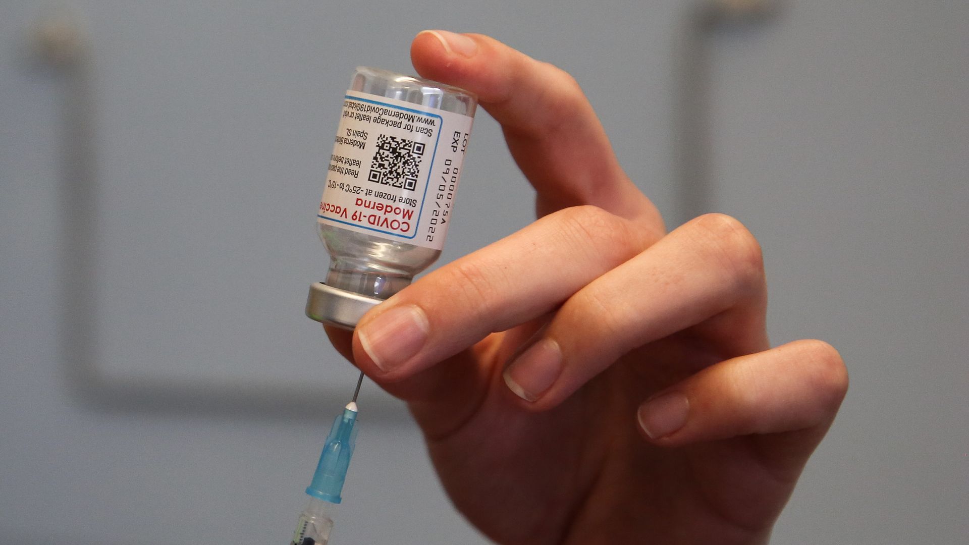 A health worker fills a syringe with Moderna COVID-19 vaccine in London in April 2022.