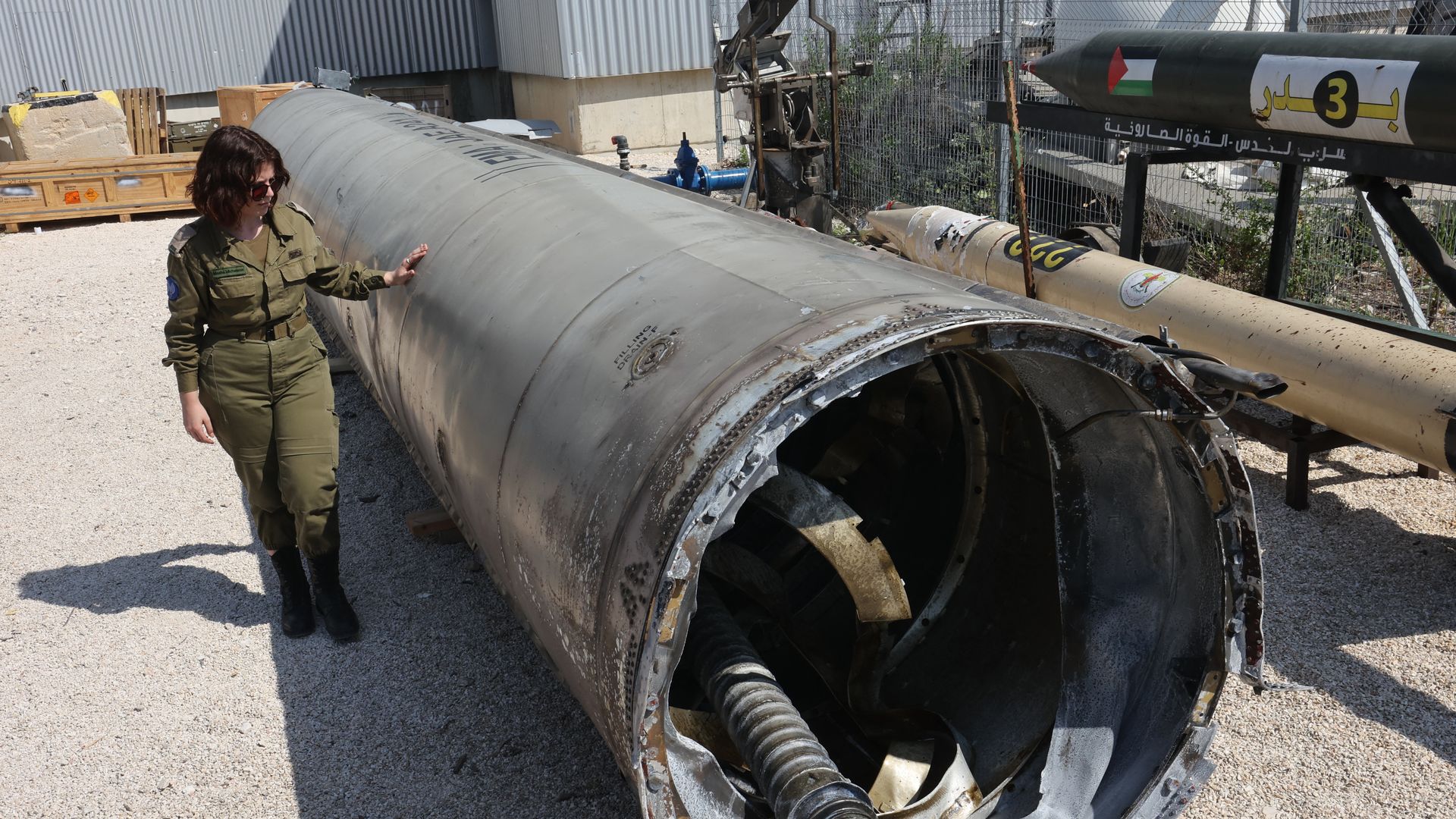 A member of the Israeli military stands next to an Iranian ballistic missile that fell in Israel on the weekend, during a media tour at the Julis military base in Israel on Apr. 16, 2024. Photo: Gil Cohen-Magen/AFP via Getty Images