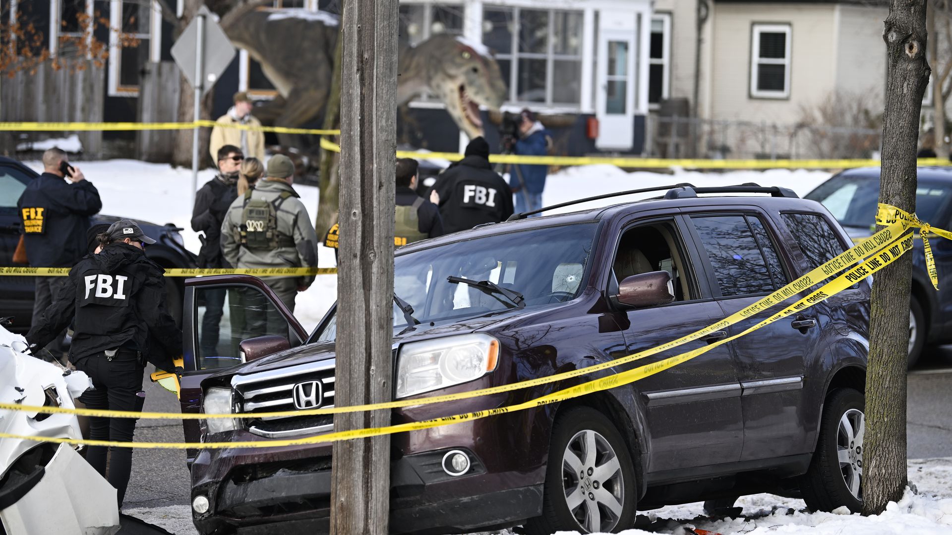 Photo of crime scene with snow in the foreground and FBI agents