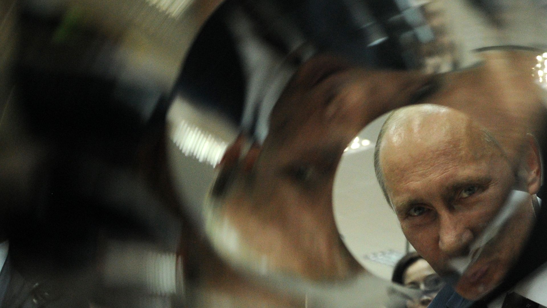 Photo of Russian President Vladimir Putin looking through a tube