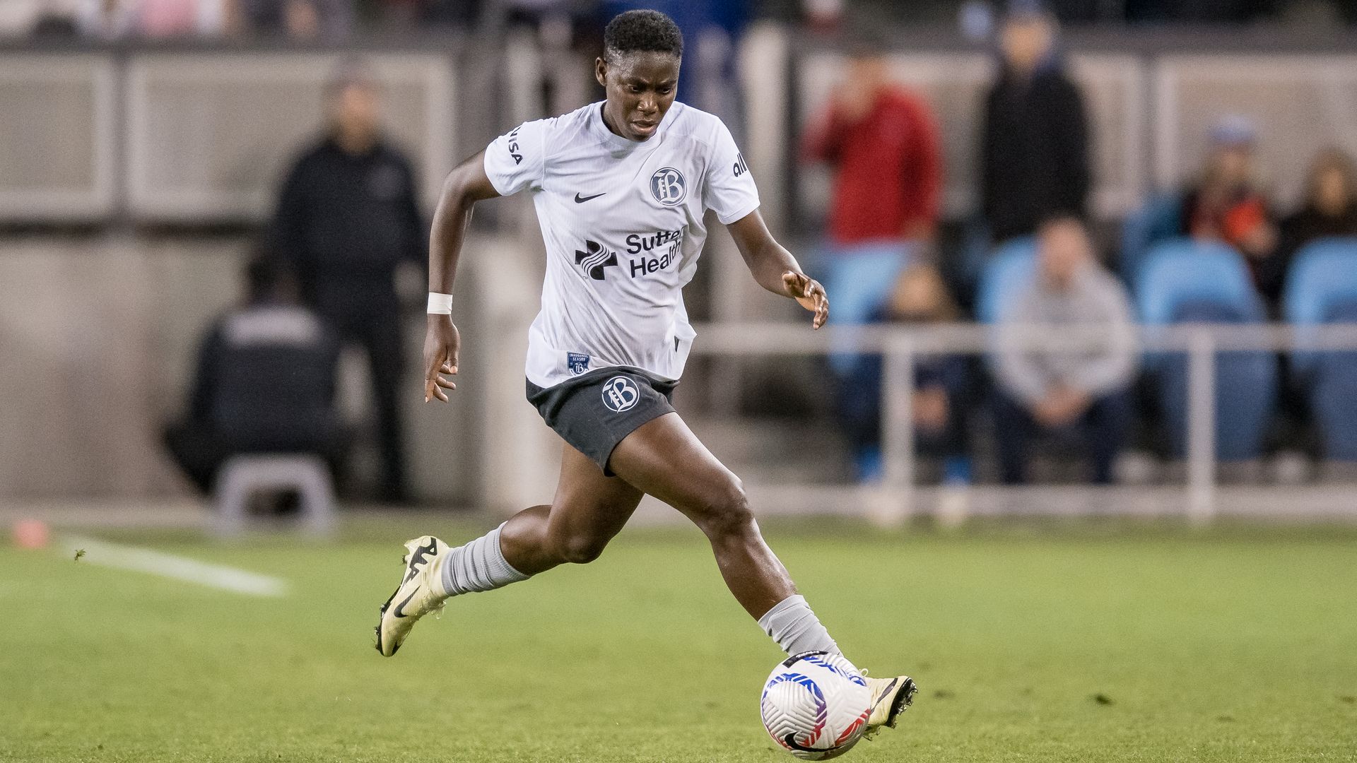 woman kicking soccer ball