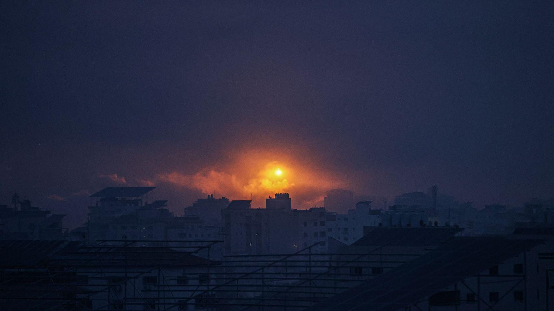 An explosion lights the night sky during an Israeli airstrike in Gaza.