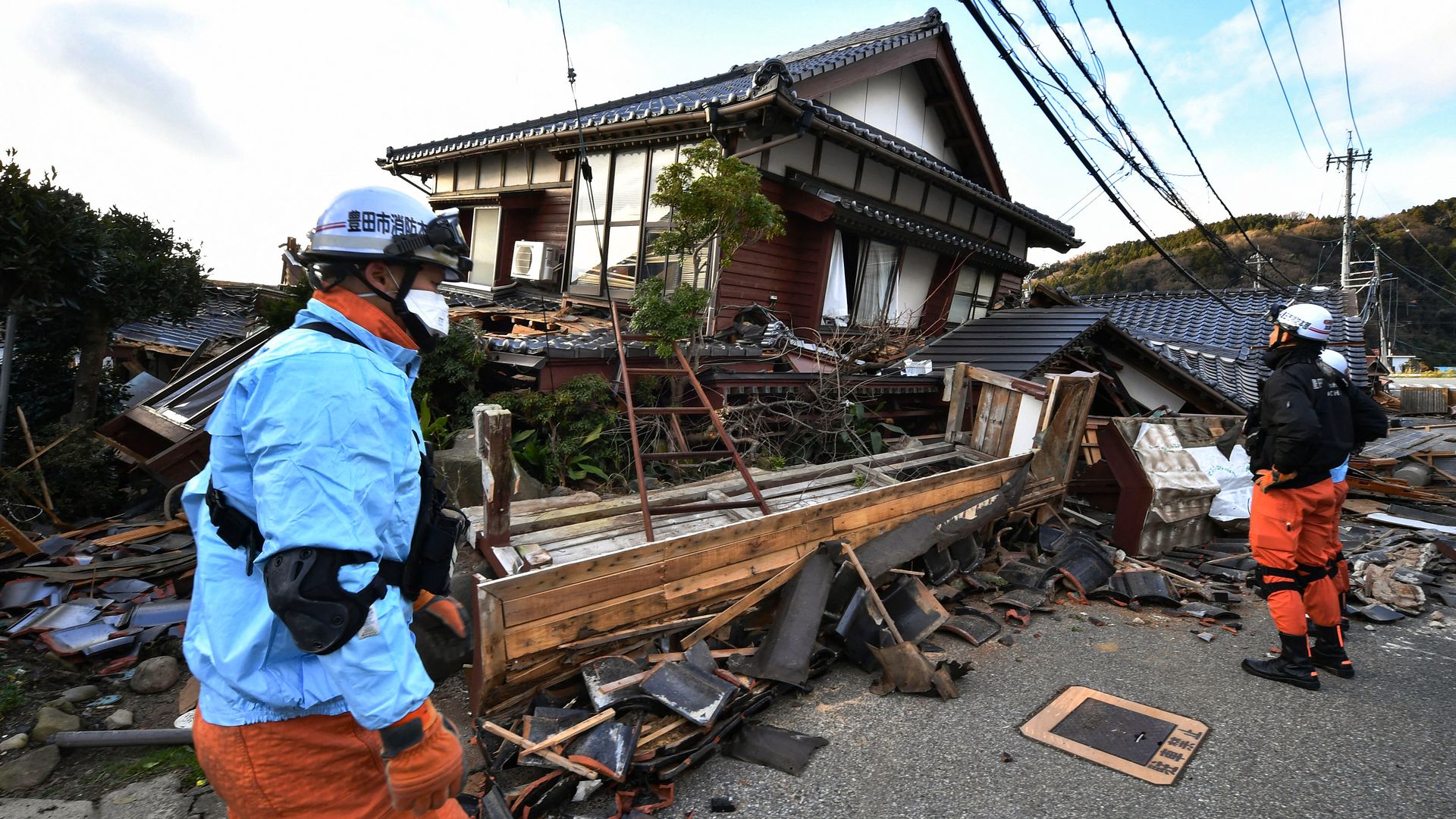  Firefighters inspect collapsed wooden houses in Wajima, Ishikawa prefecture on January 2, 2024, a day after a major 7.5 magnitude earthquake struck the Noto region in Ishikawa prefecture in the afternoon. 