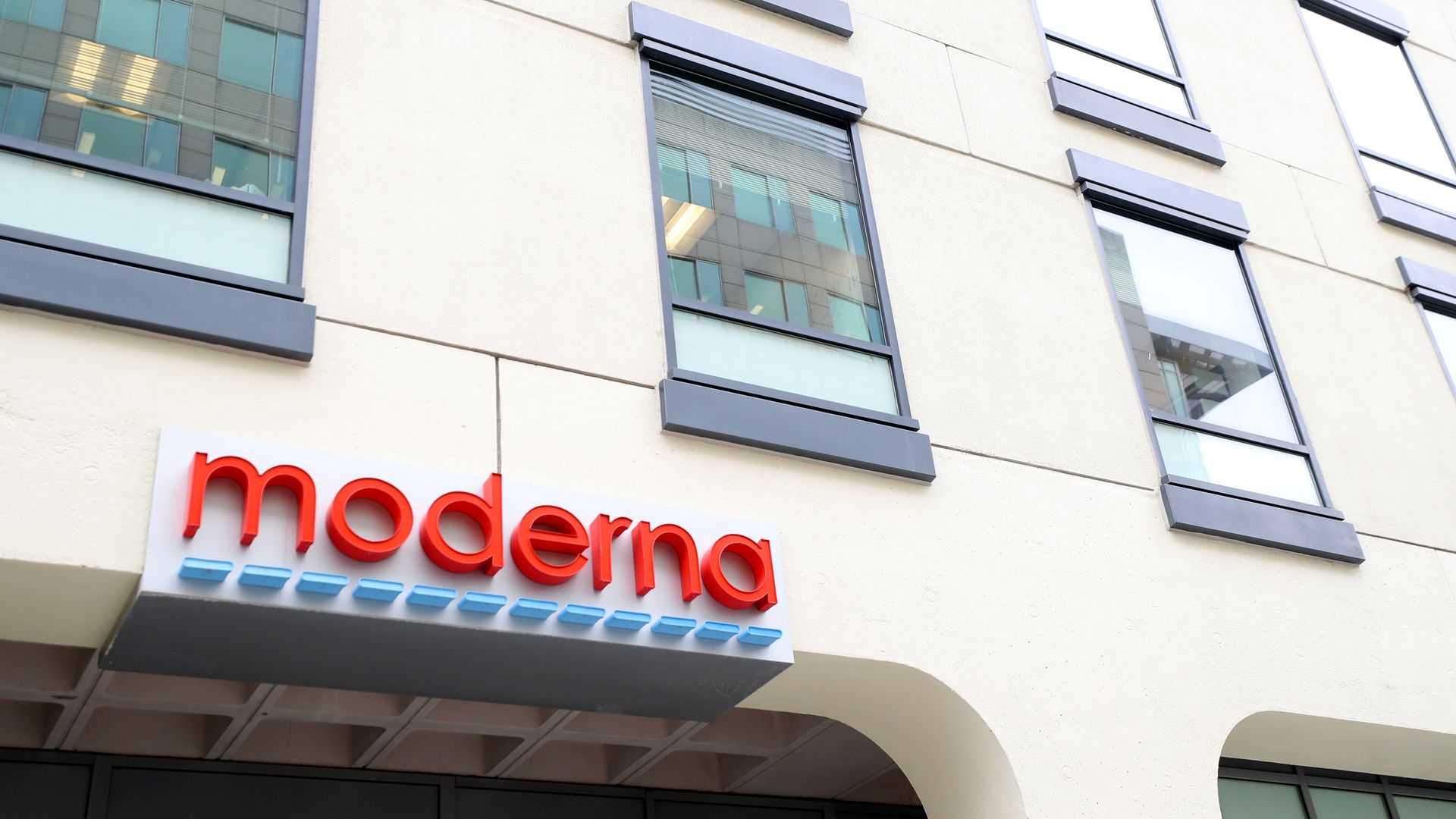 Moderna's red logo atop its headquarters building.