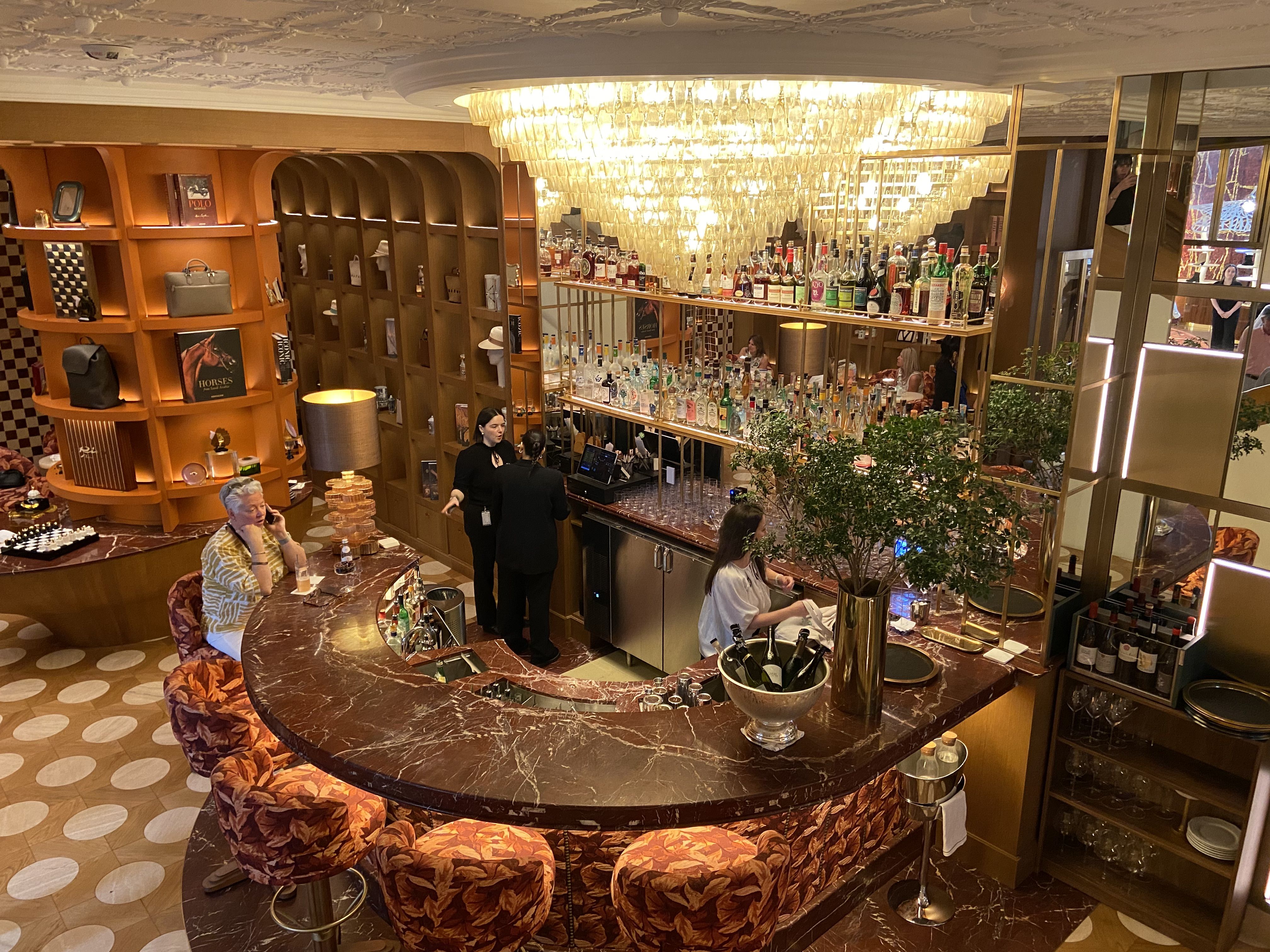 An overhead view of a bar with a large chandelier 