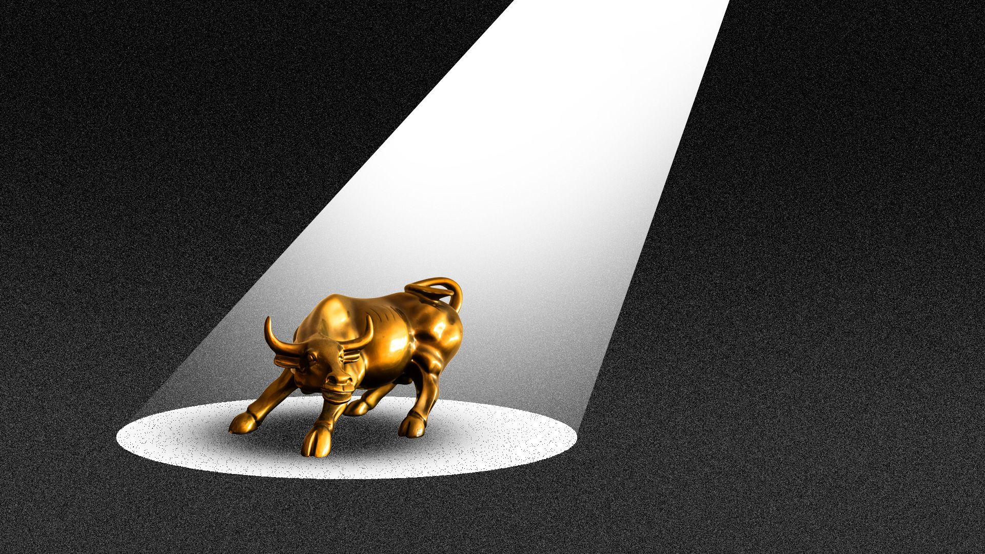 The Wall Street bull being illuminated by a spotlight