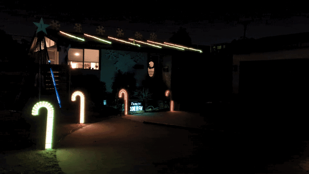 Holiday lights flash outside a house