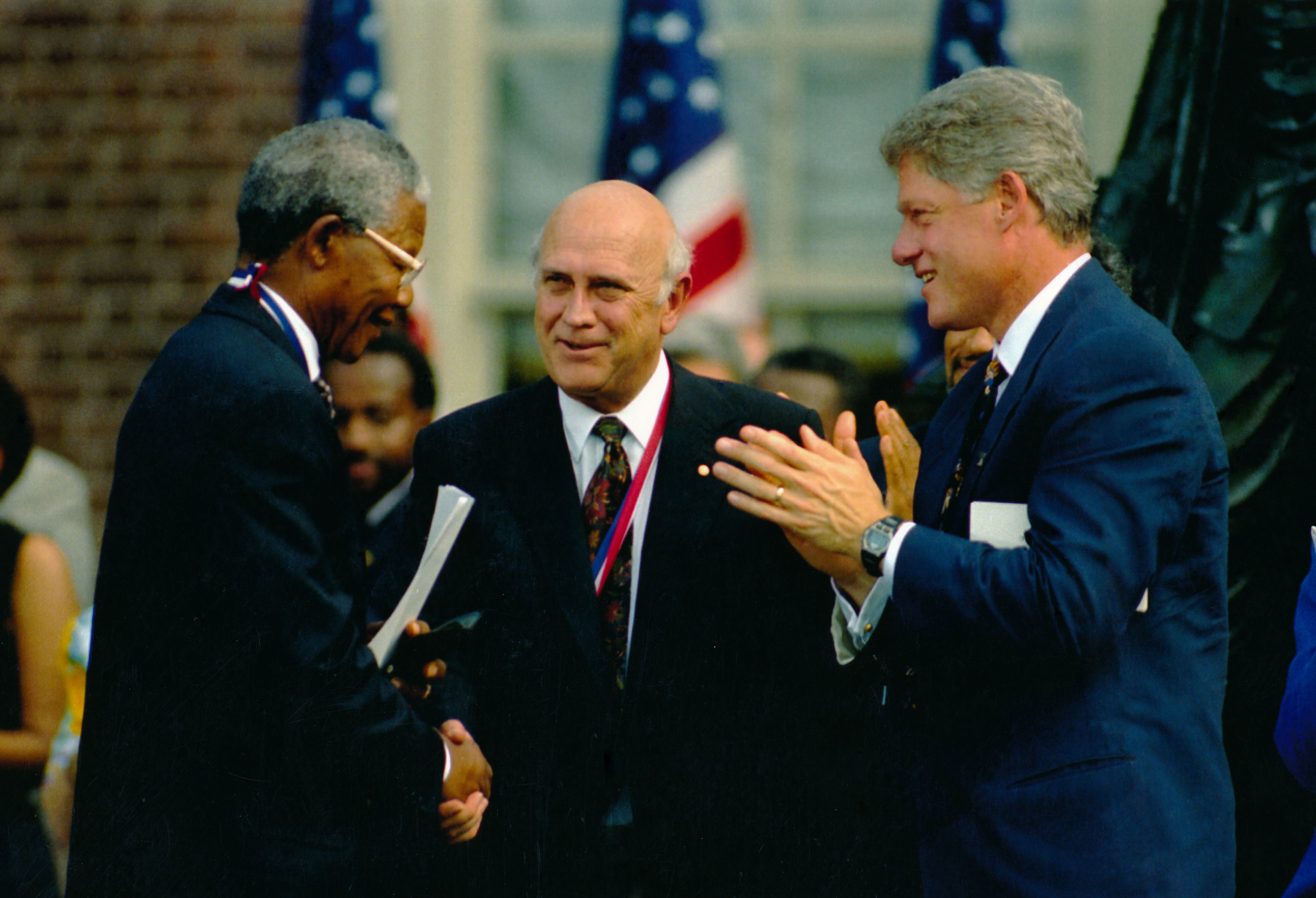 Nelson Mandela (left) and President FW de Klerk (centre) are congratulated by President Bill Clinton after jointly receiving the Liberty Medal at Independence Hall, Philadelphia, July, 4 1993. 
