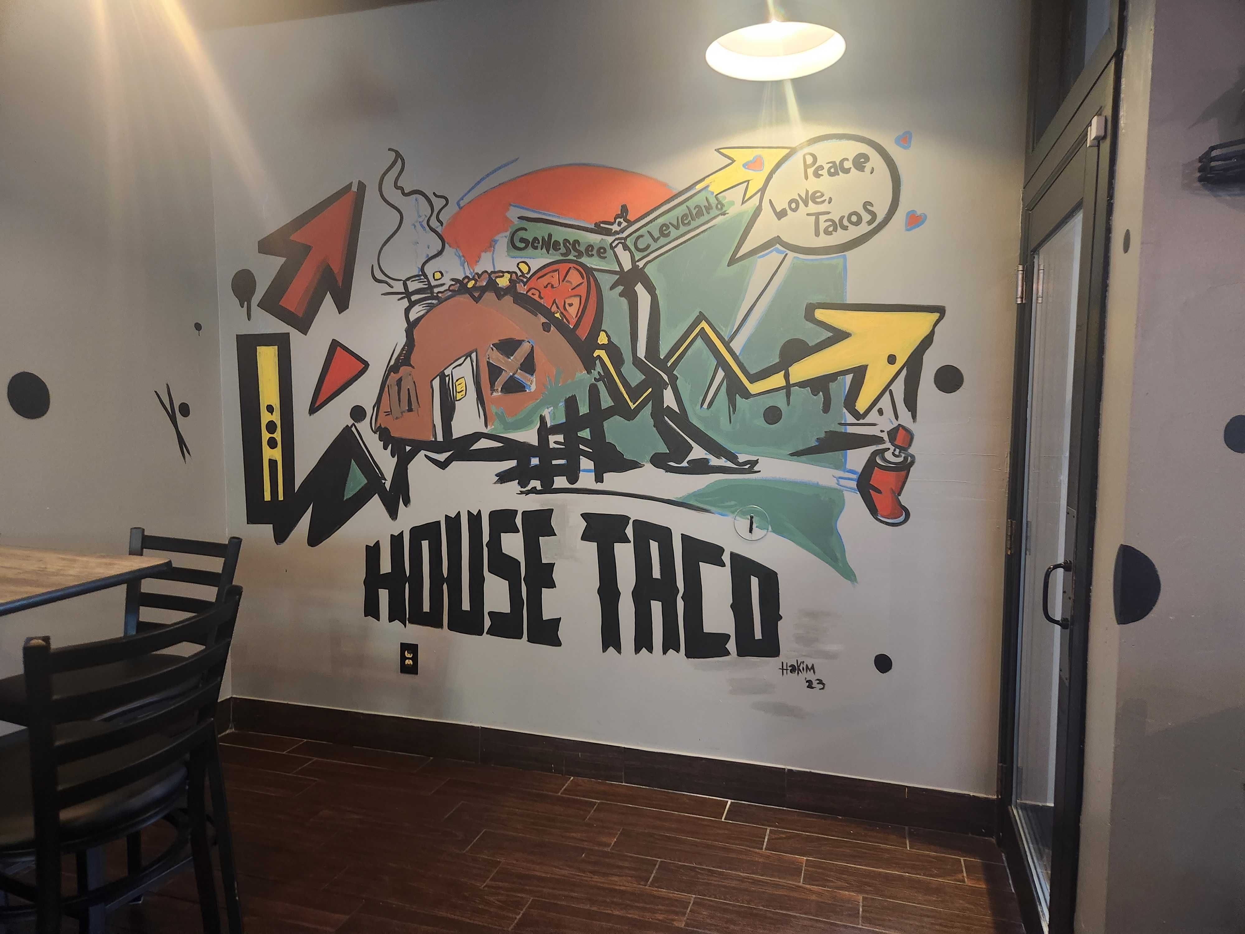 A business mural for "House Taco" reading "Peace, Love, Tacos"