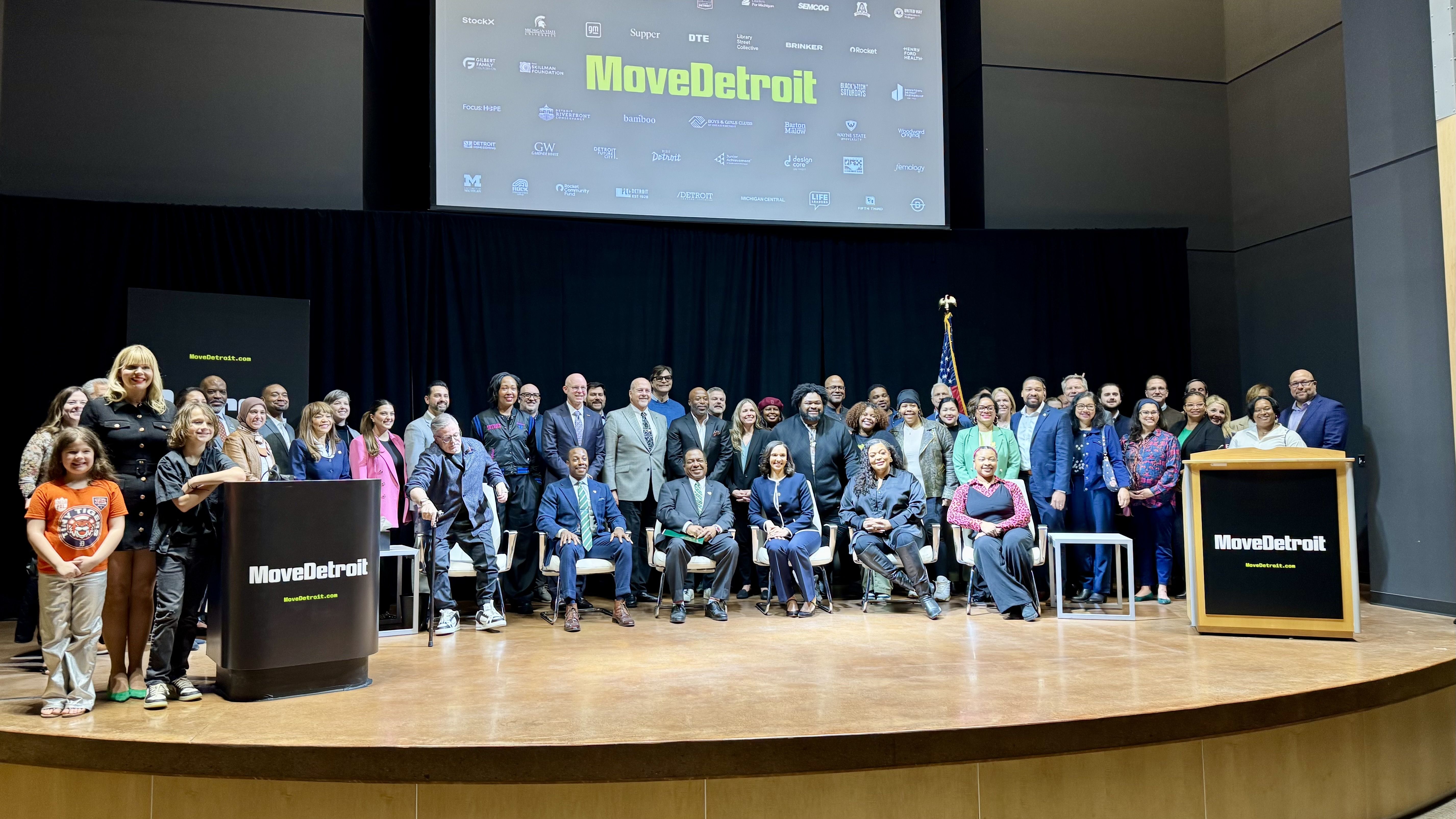 A group of people posing on stage 