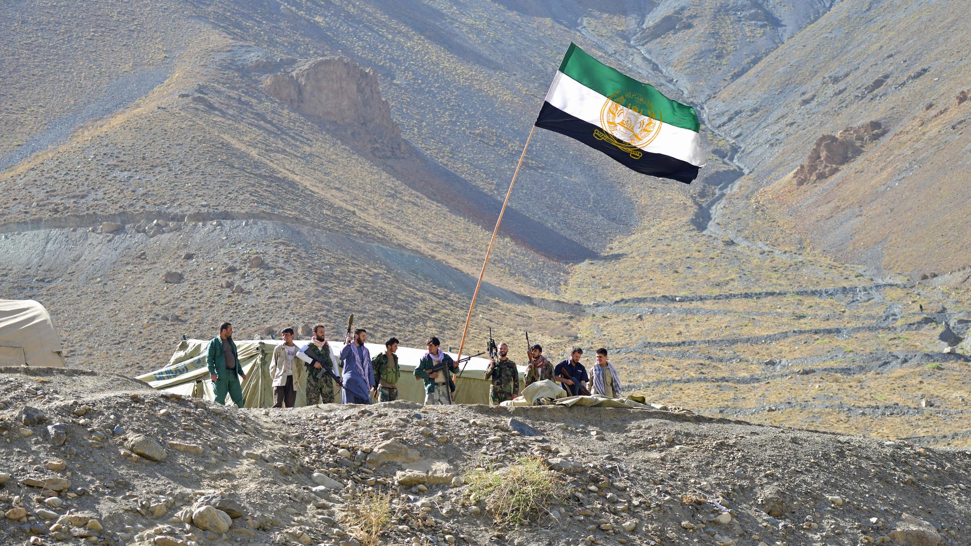 Afghan resistance movement and anti-Taliban uprising forces stand guard on a hilltop in the Astana area of Bazarak in Panjshir province on August 27