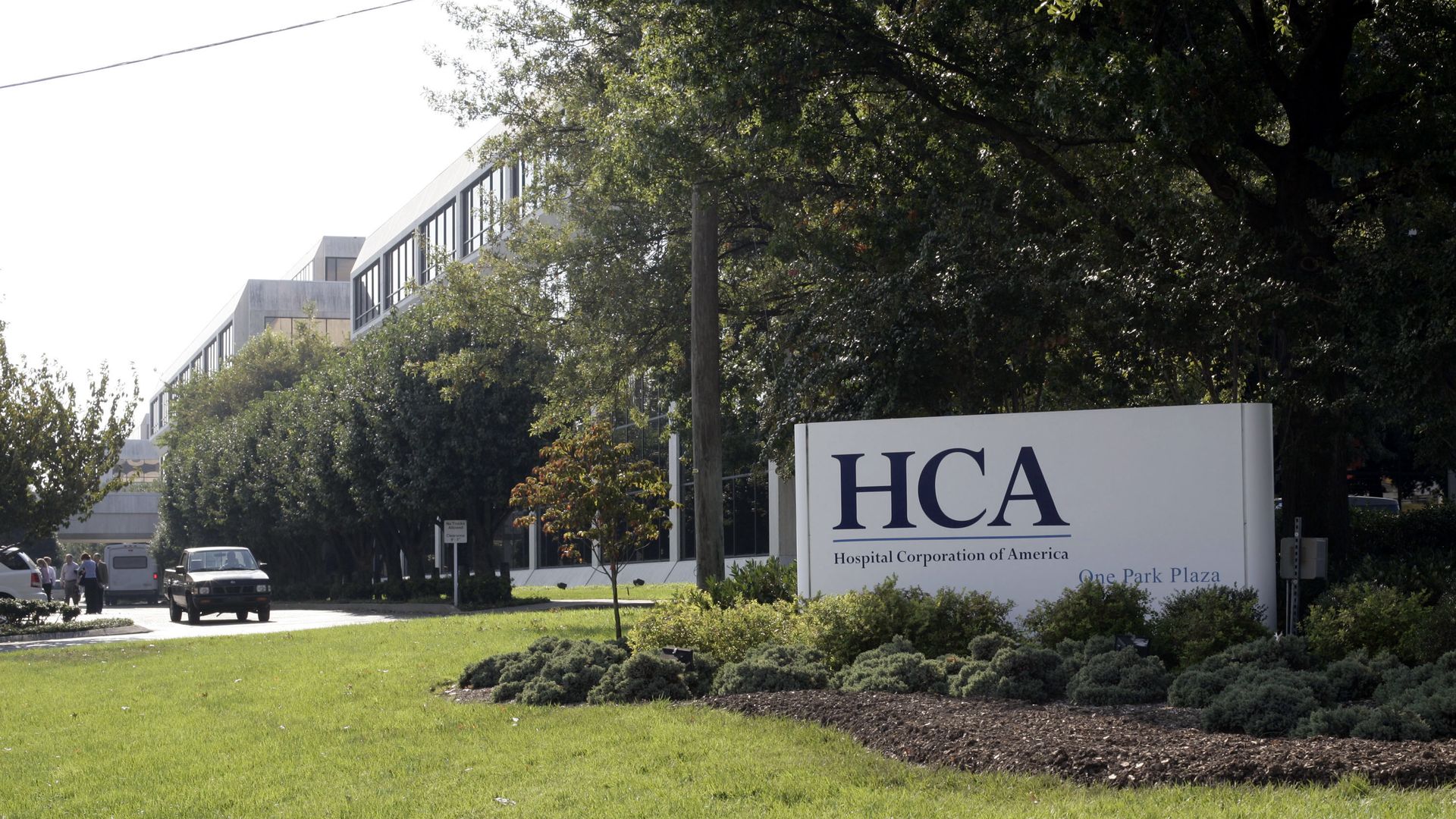 HCA Healthcare sign in front of trees.