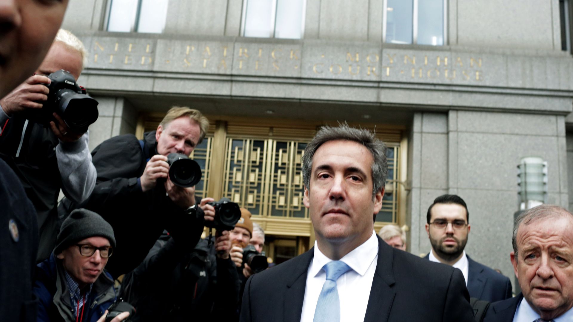 Michael Cohen in a crowd of photographers