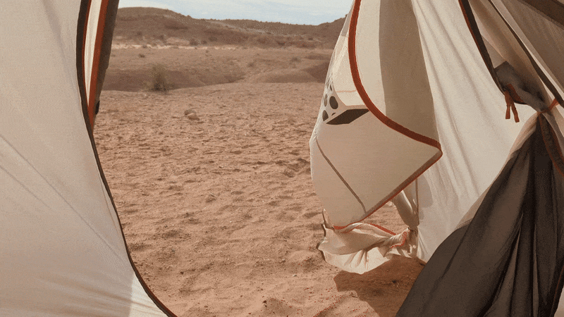 A GIF of a tent door whipping in the wind