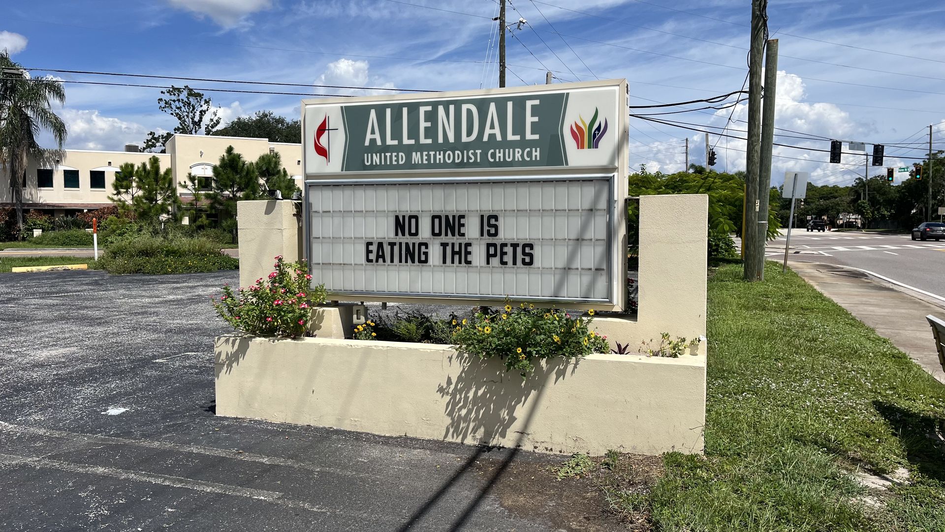 A sign for Allendale United Methodist Church with a marquee that reads, "No one is eating the pets."