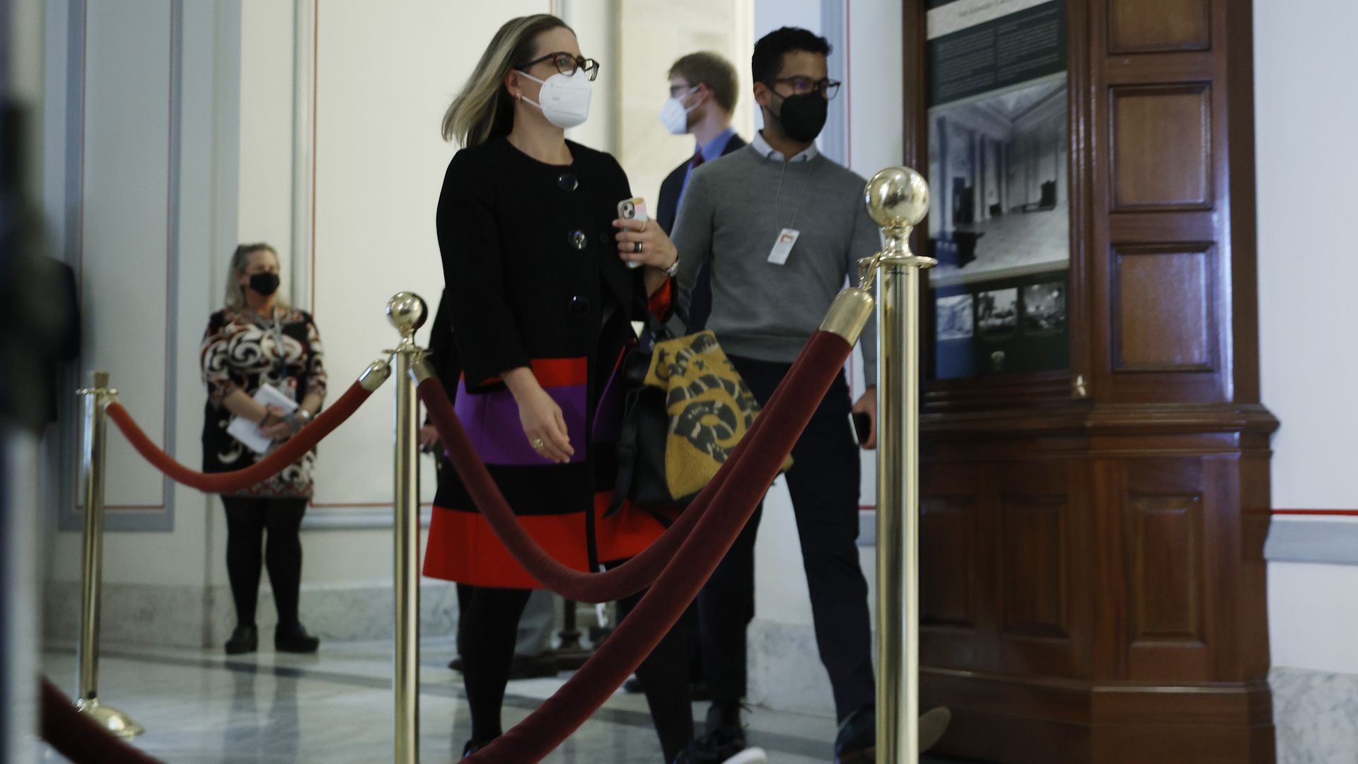 Sen. Kyrsten Sinema is seen entering a caucus meeting with President Biden