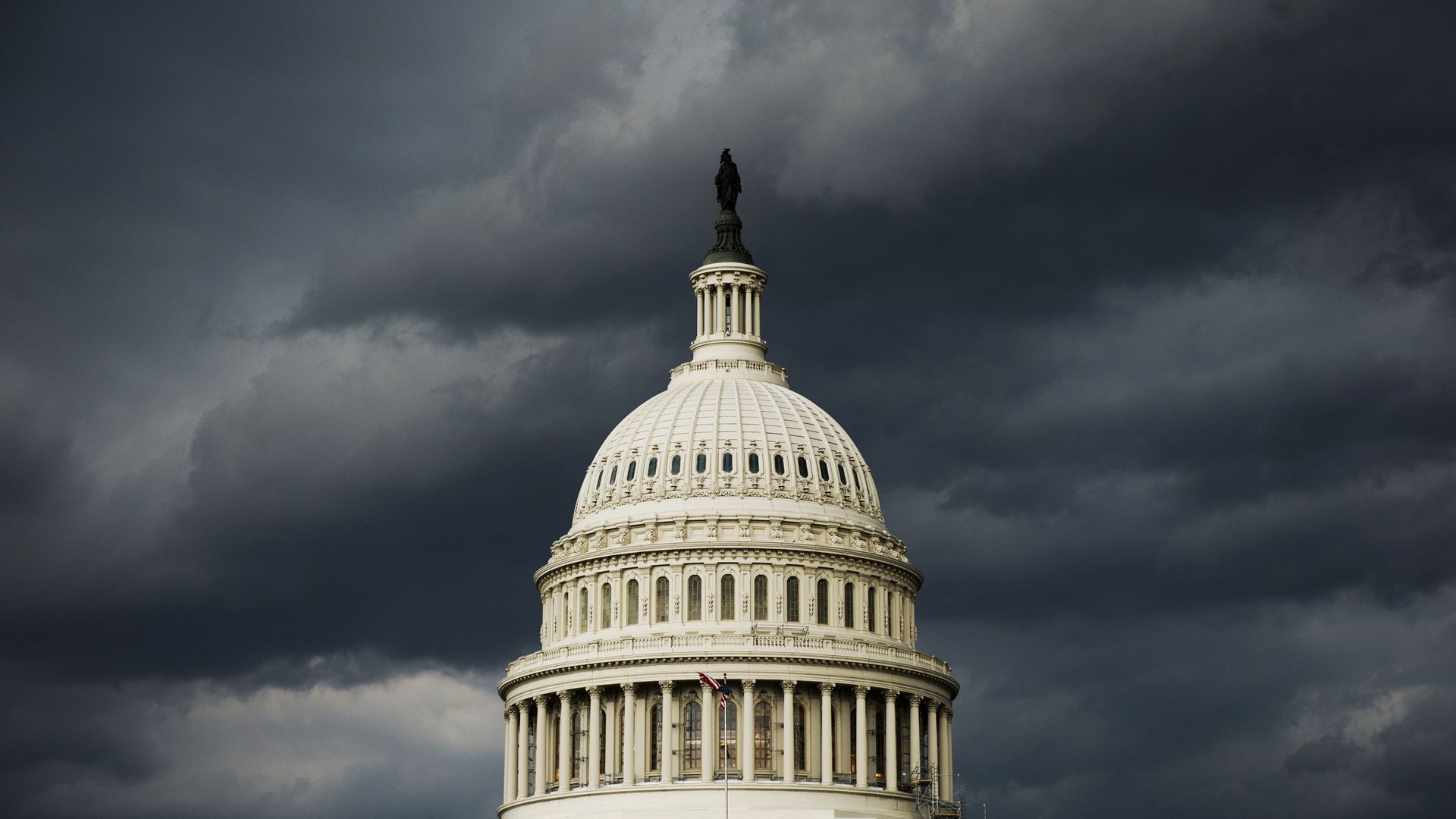The Capitol Dome under storm clouds