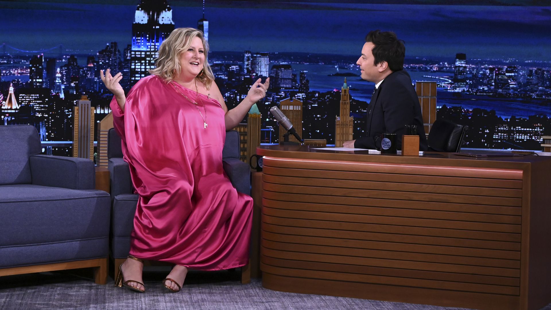 Woman in a pink dress on Fallon show. 