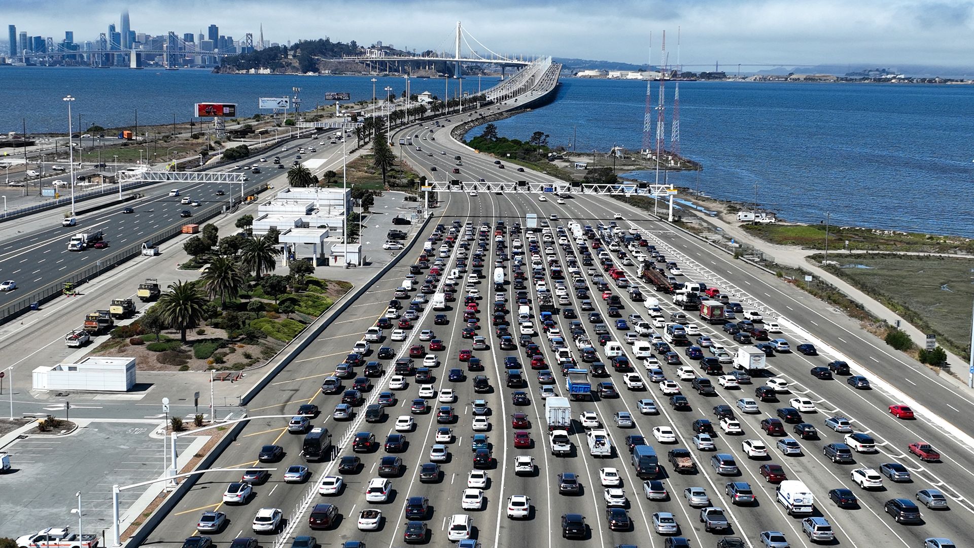 Traffic backs up at the San Francisco-Oakland Bay Bridge toll plaza on August 24, 2022 in Oakland, California. California is set to implement a plan to prohibit the sale of new gasoline-powered cars in the state by 2035 in an effort to fight climate change by transitioning to electric vehicles. (Pho
