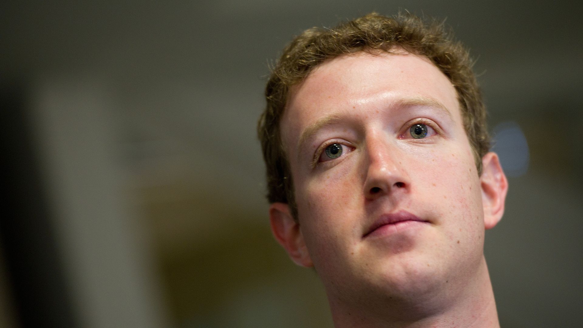 Mark Zuckerberg looks away from the camera