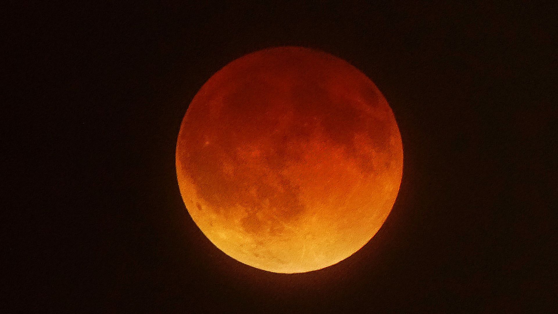 The full Moon appears reddish-orange during a "Blood Moon" total lunar eclipse.