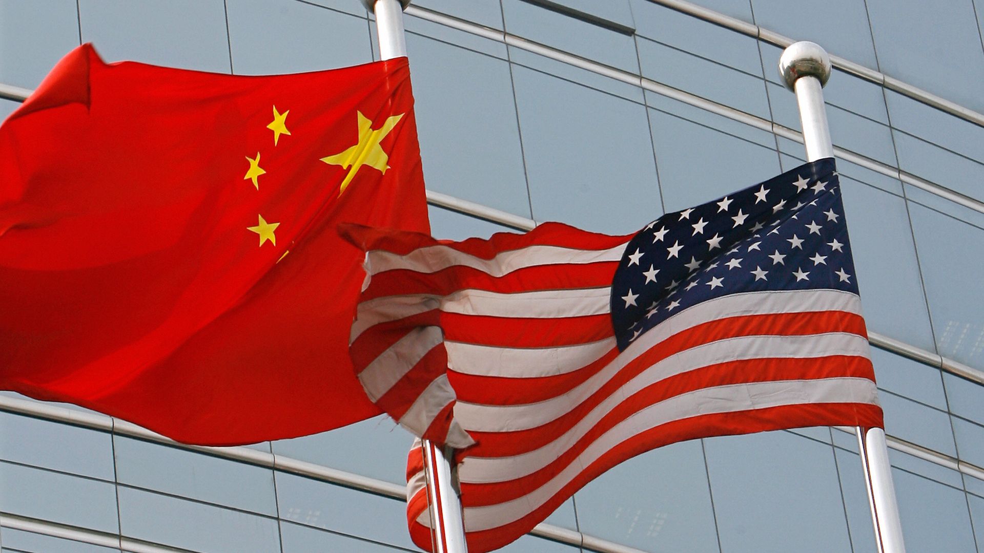 A US and a Chinese flag wave side by side
