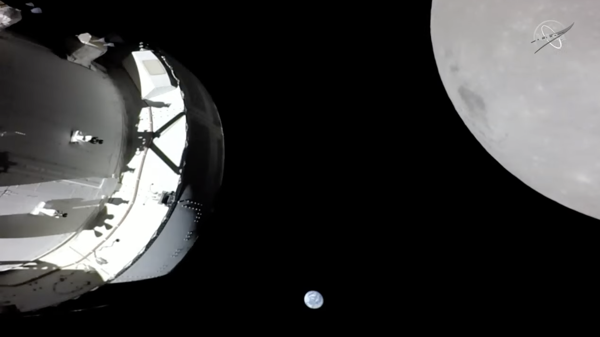 Orion (left) sees the Earth (center) and Moon as it makes a close flyby of the lunar body