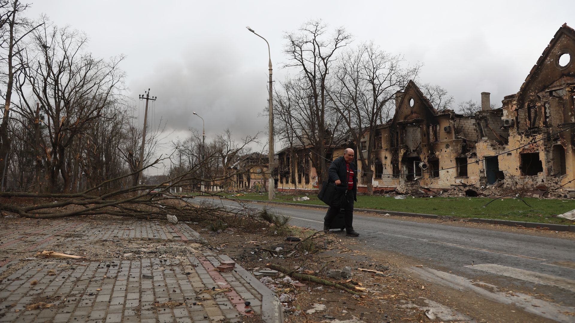 A person walking down a ruined street in Mariupol on April 8.