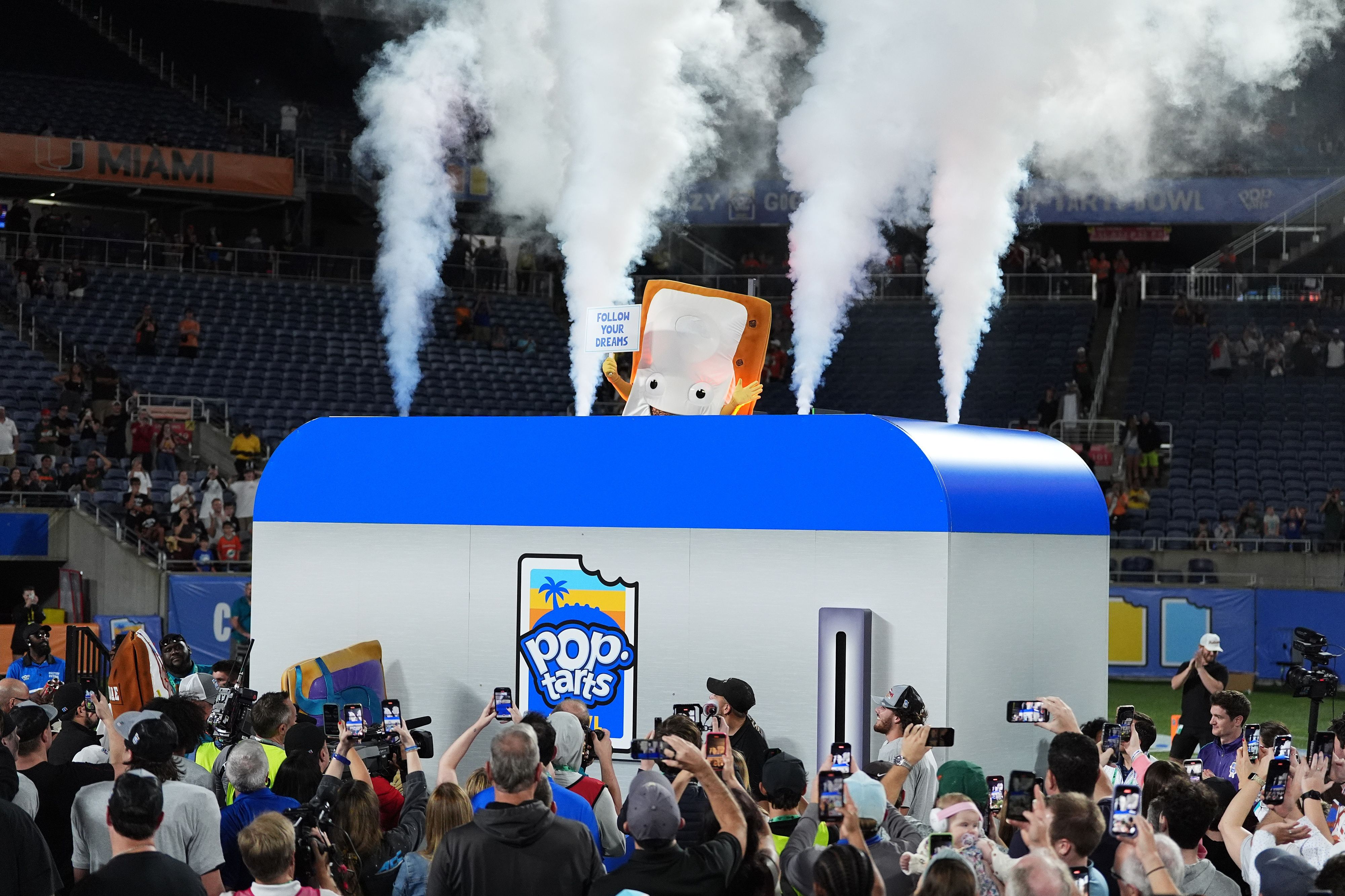 Dec 28, 2024; Orlando, FL, USA; The Cinnamon Pop-Tart mascot goes into a toaster to be toasted after the Iowa State Cyclones defeatied the Miami Hurricanes at Camping World Stadium. Mandatory Credit: Jasen Vinlove-Imagn Images
