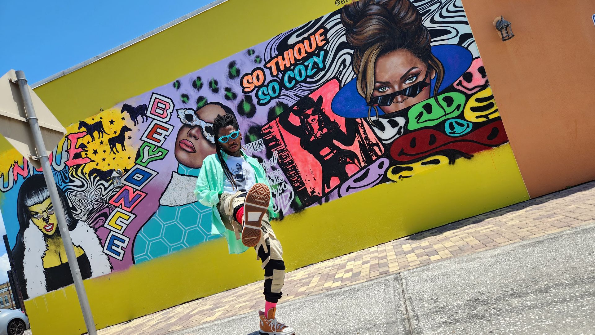Cam Parker does a high kick in front of his Beyonce mural