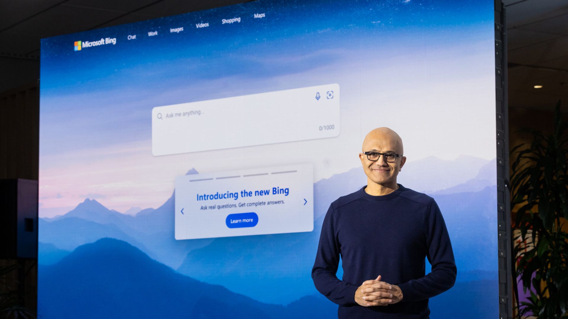 Microsoft CEO Satya Nadella standing in front of the AI-infused Bing search engine