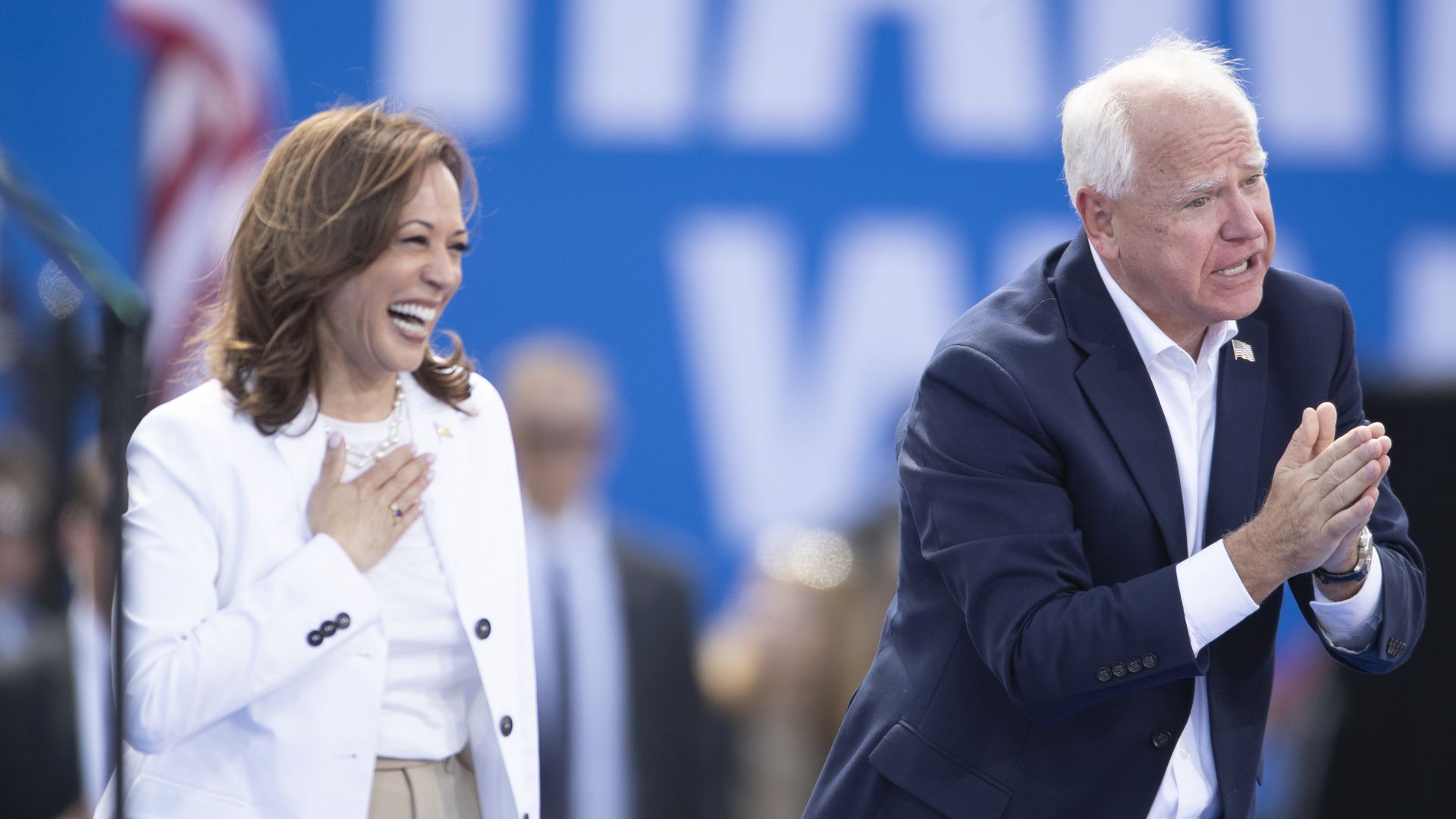 Harris, left, and Walz, right, greet an audience at a rally 