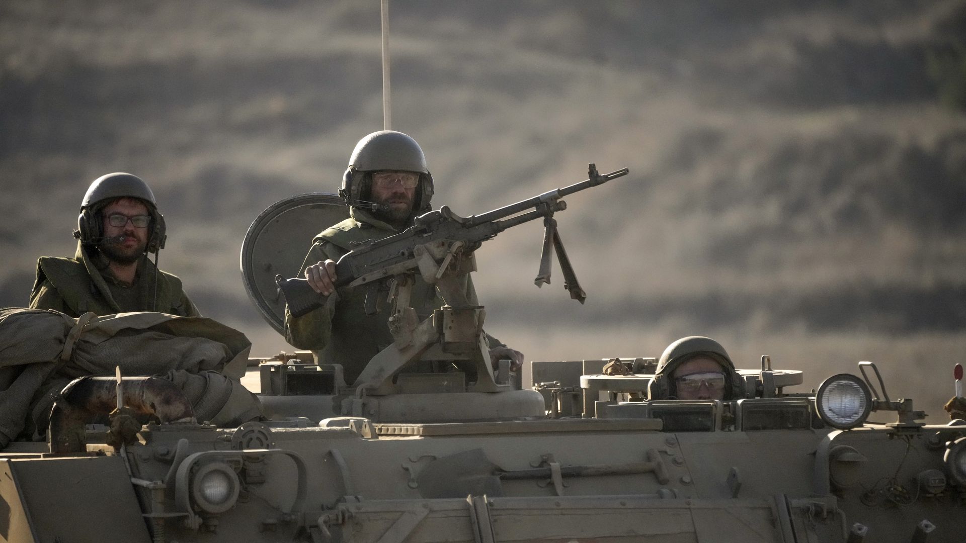 Israeli soldiers stand ready in their armoured personnel carrier (APC) in the Golan Heights near the Israeli border with Lebanon on November 10, 2023 near Kiryat Shmona, Israel.