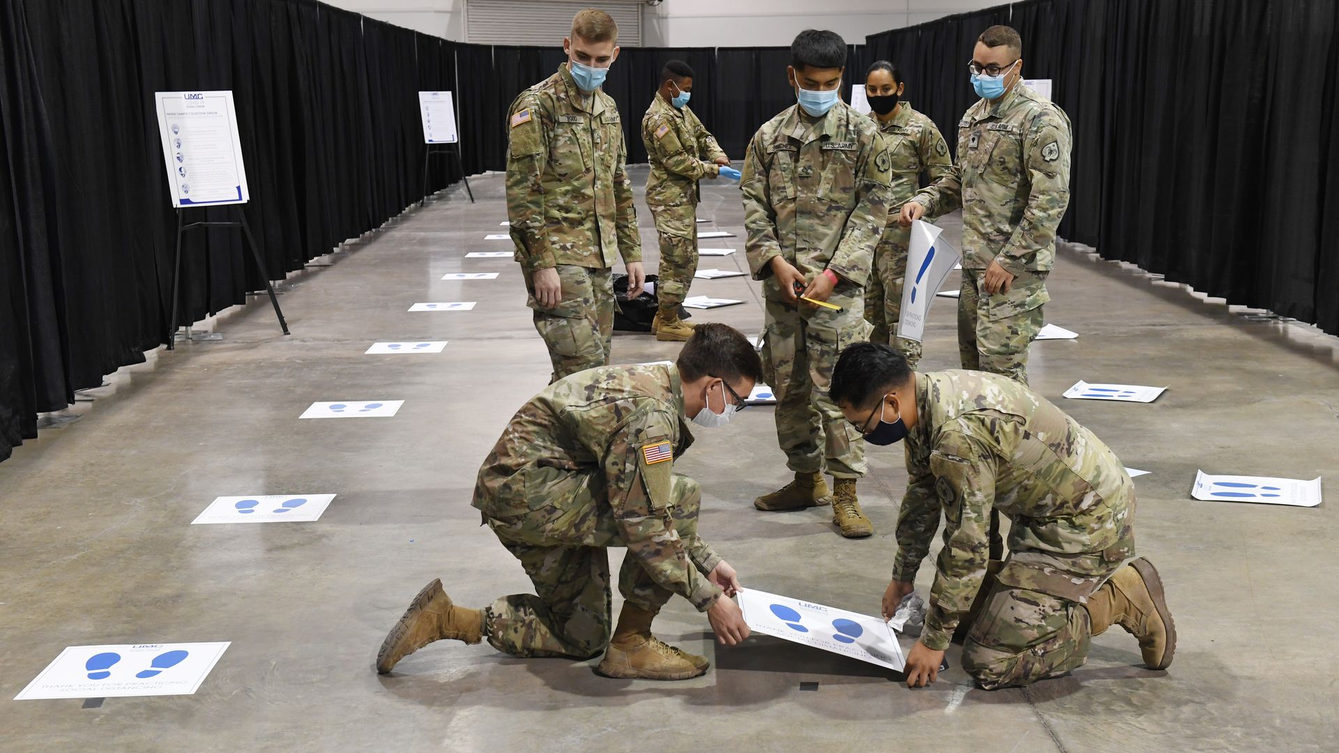 Members of the Nevada National Guard put down social distancing decals at a new coronavirus (COVID-19) testing site inside Cashman Center on August 3, 2020 in Las Vegas, Nevada. 