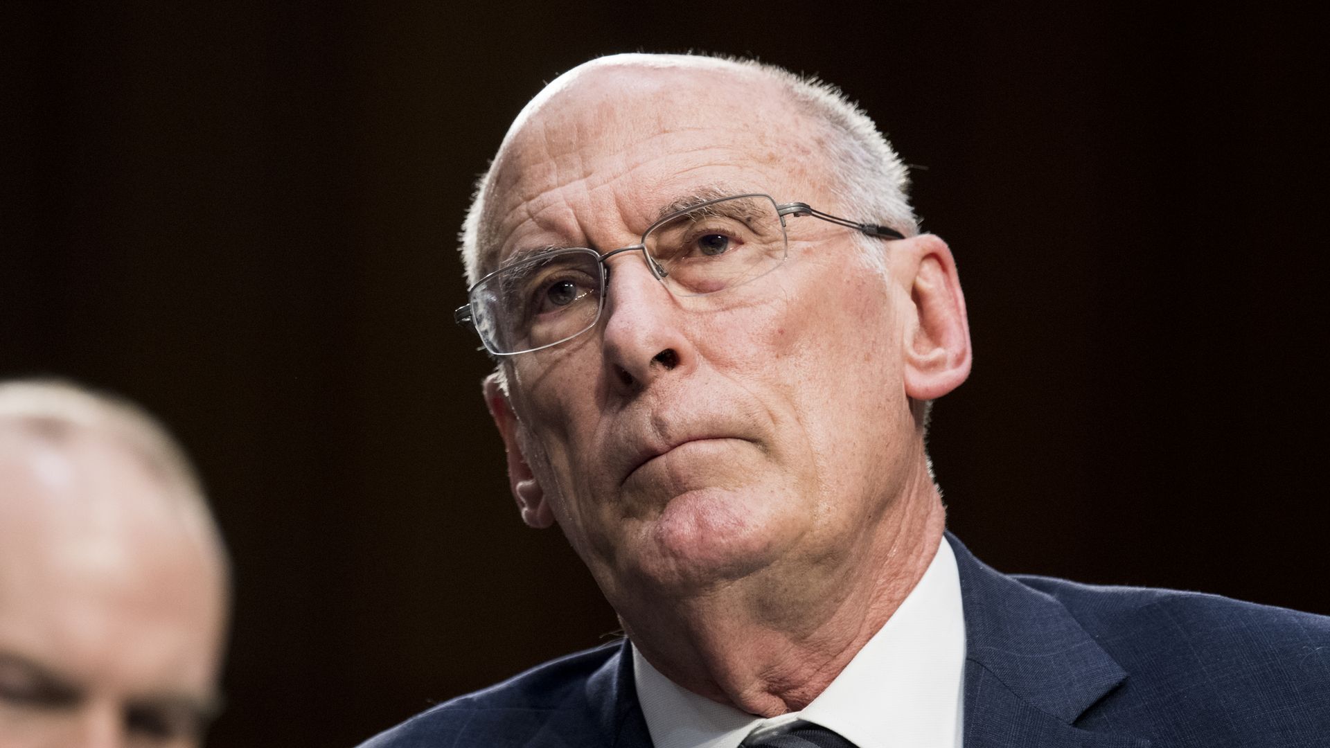 In this image, Dan Coats looks forward.