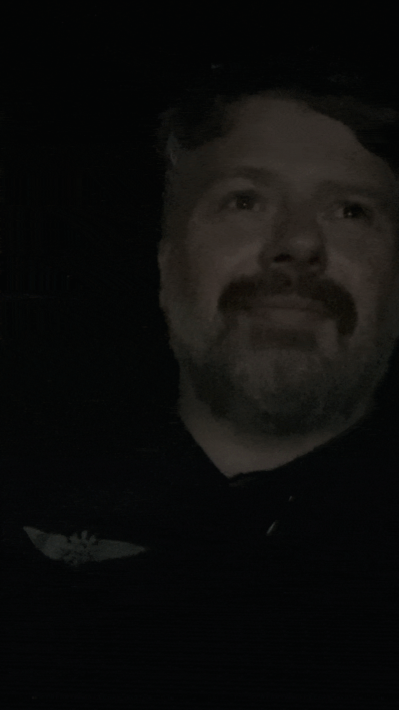 A man in smiles as his 4DX theater seat shakes and rattles repeatedly.