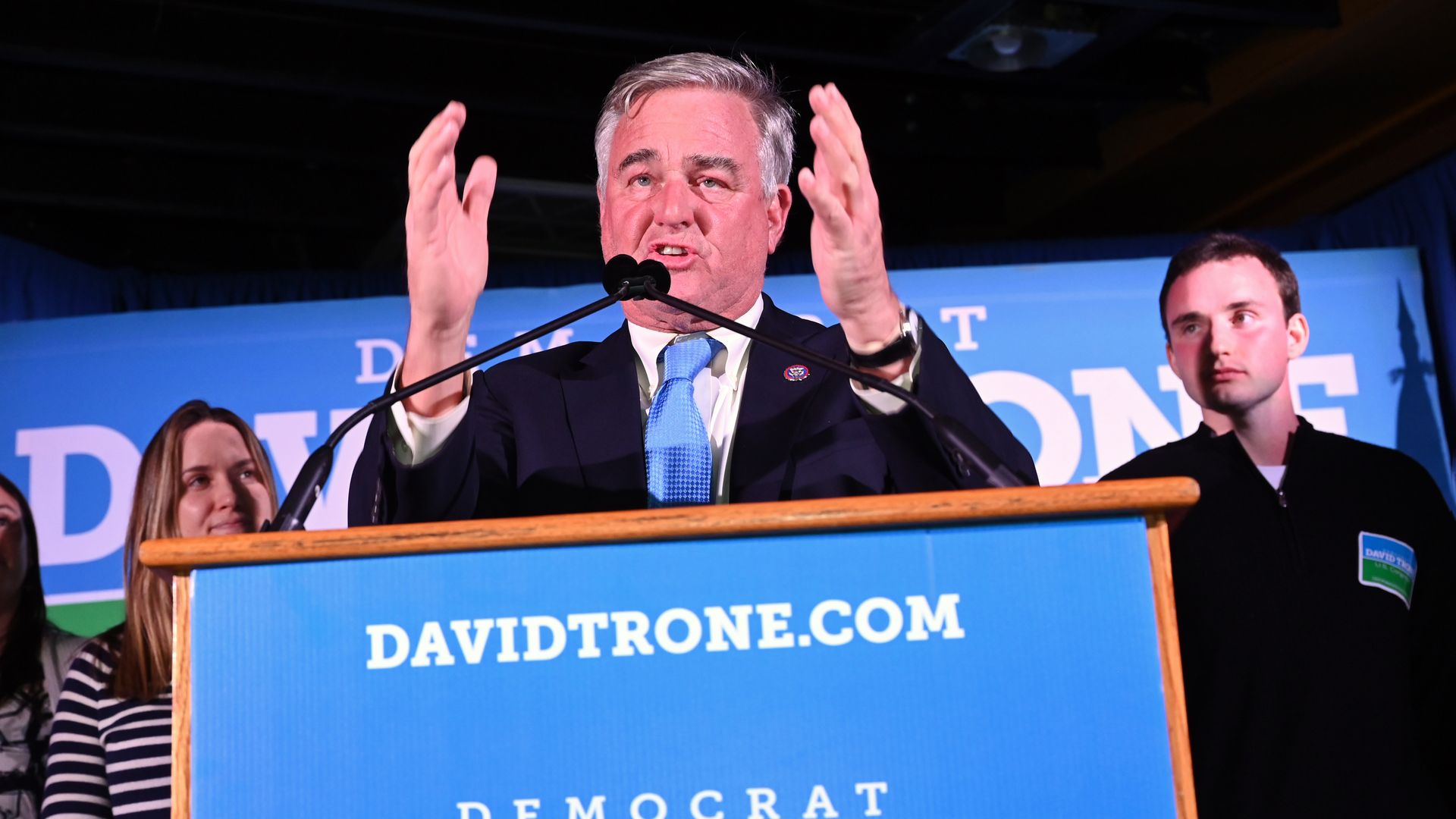 Rep. David Trone, wearing a dark blue suit, white shirt and blue tie, speaks at a campaign event.