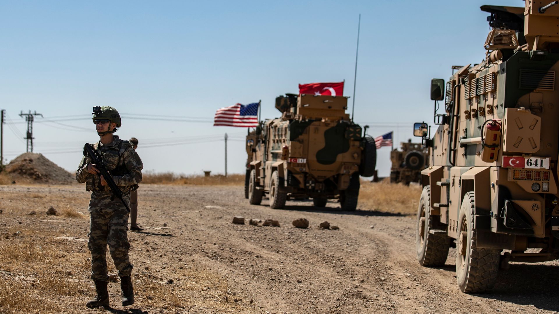 A US soldier stands guard during a joint patrol with Turkish troops in the Syrian village of al-Hashisha on the outskirts of Tal Abyad town along the border with Turkish troops, on September 8, 2019. 