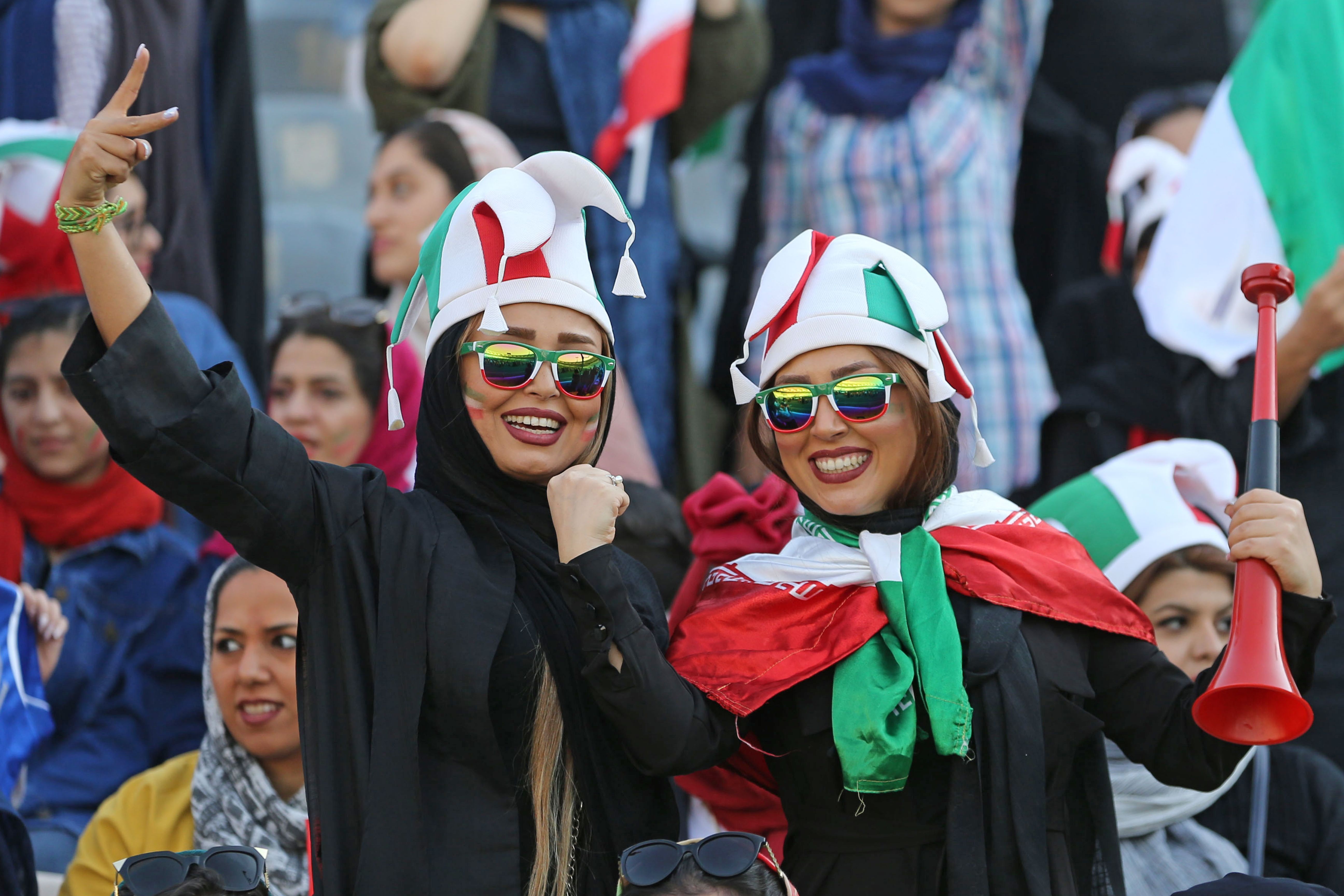 Iranian women cheering at a soccer game