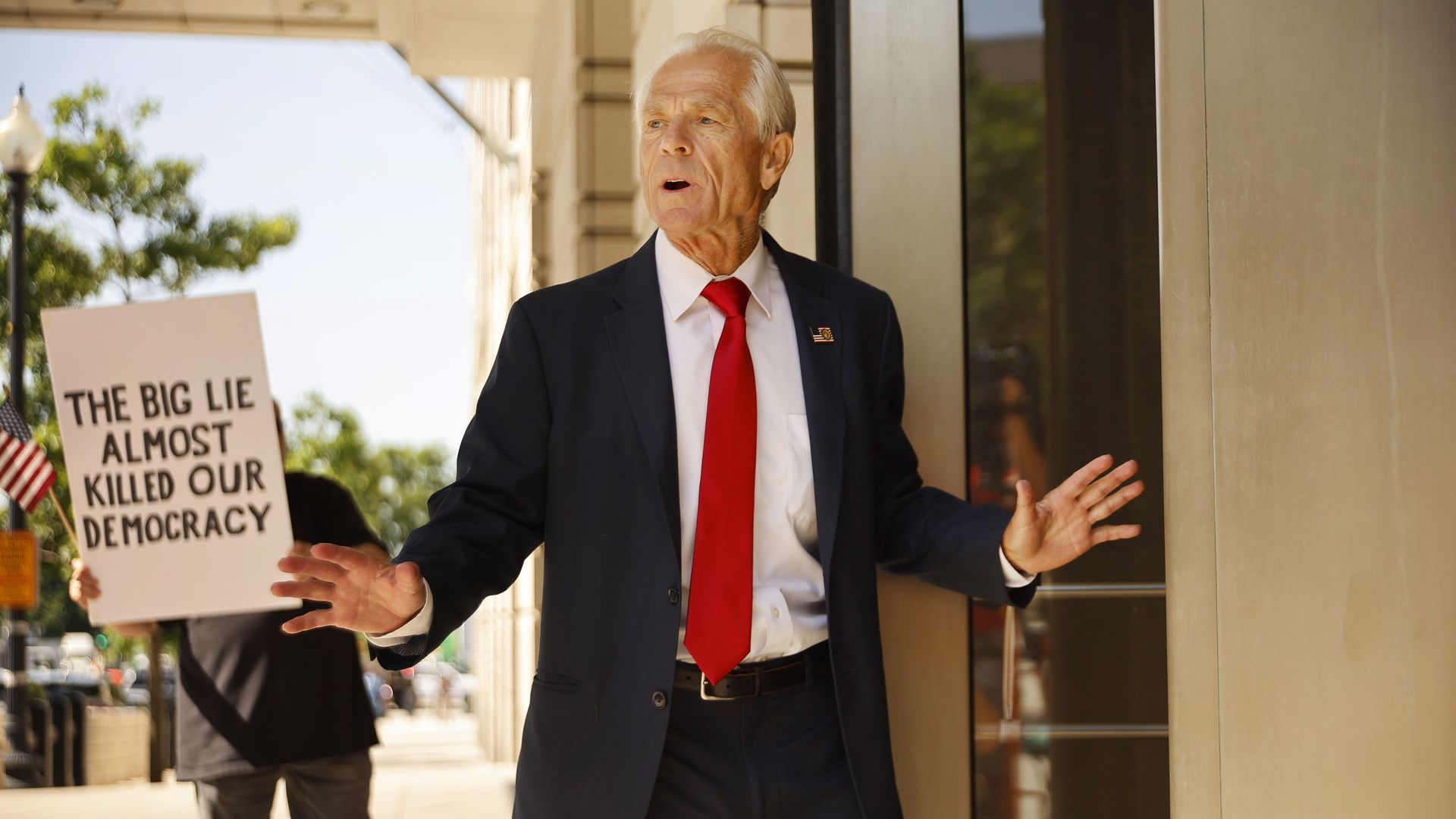 Former Trump White House Advisor Peter Navarro arriving at court followed by a demonstrator in Washington, D.C., on June 17.