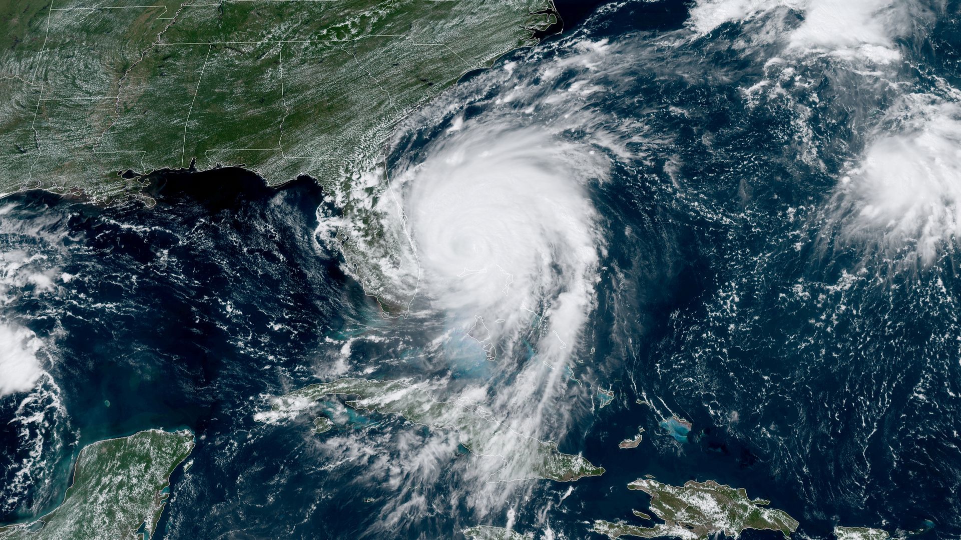This image shows a satellite view of Hurricane Dorian approaching Florida and the East Coast.
