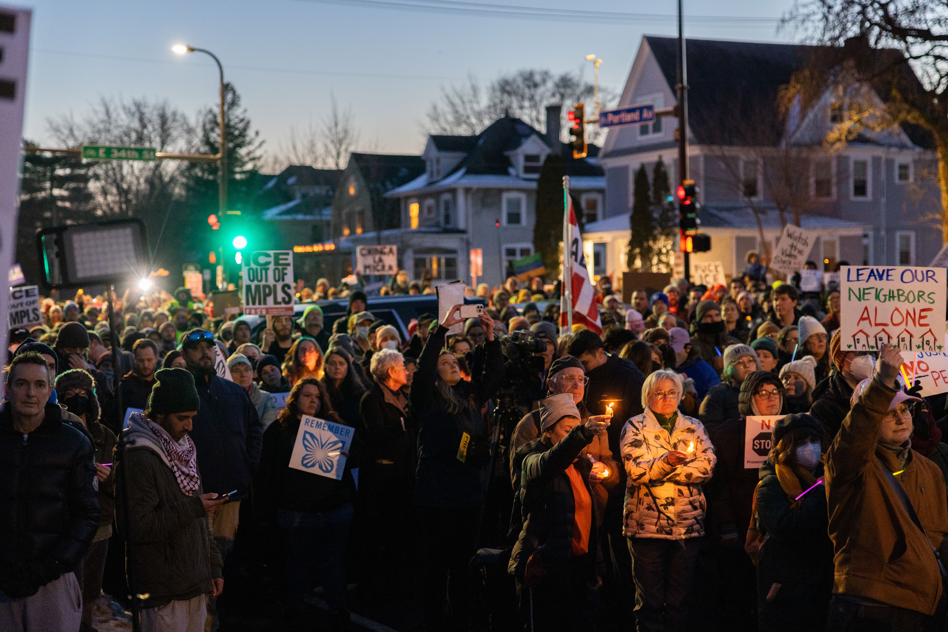 A vigil at the scene where an ICE agent fatally shot a woman yesterday.