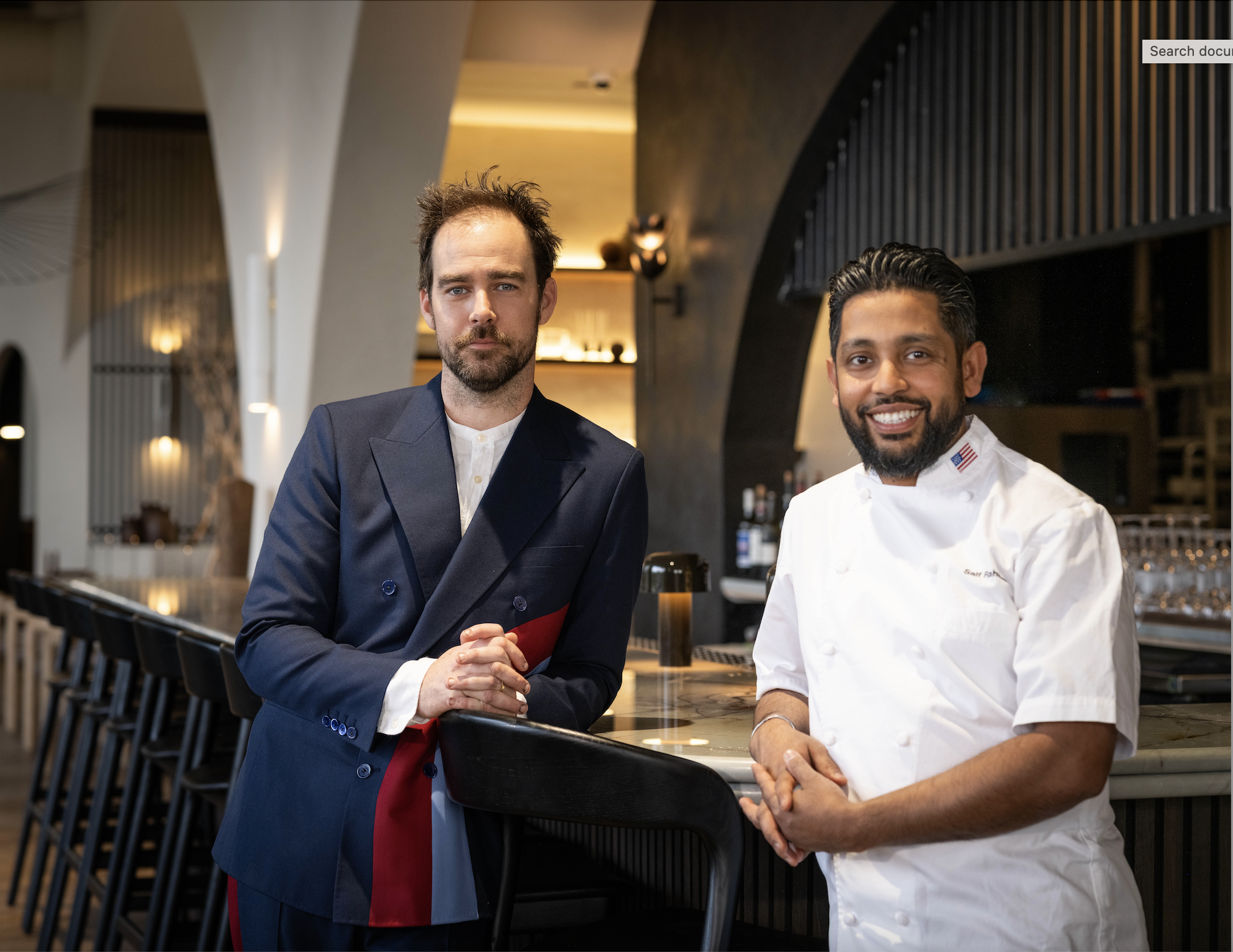 Patrick Shanahan and Saif Rahman stand next to the bar of Peregrine