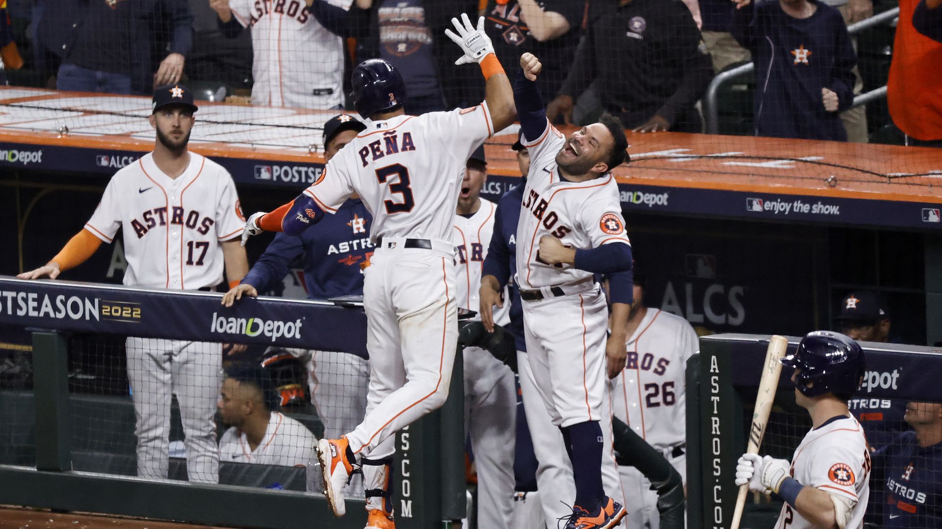 Astros stars Jeremy Peña and Jose Altuve jump in celebration after a hit