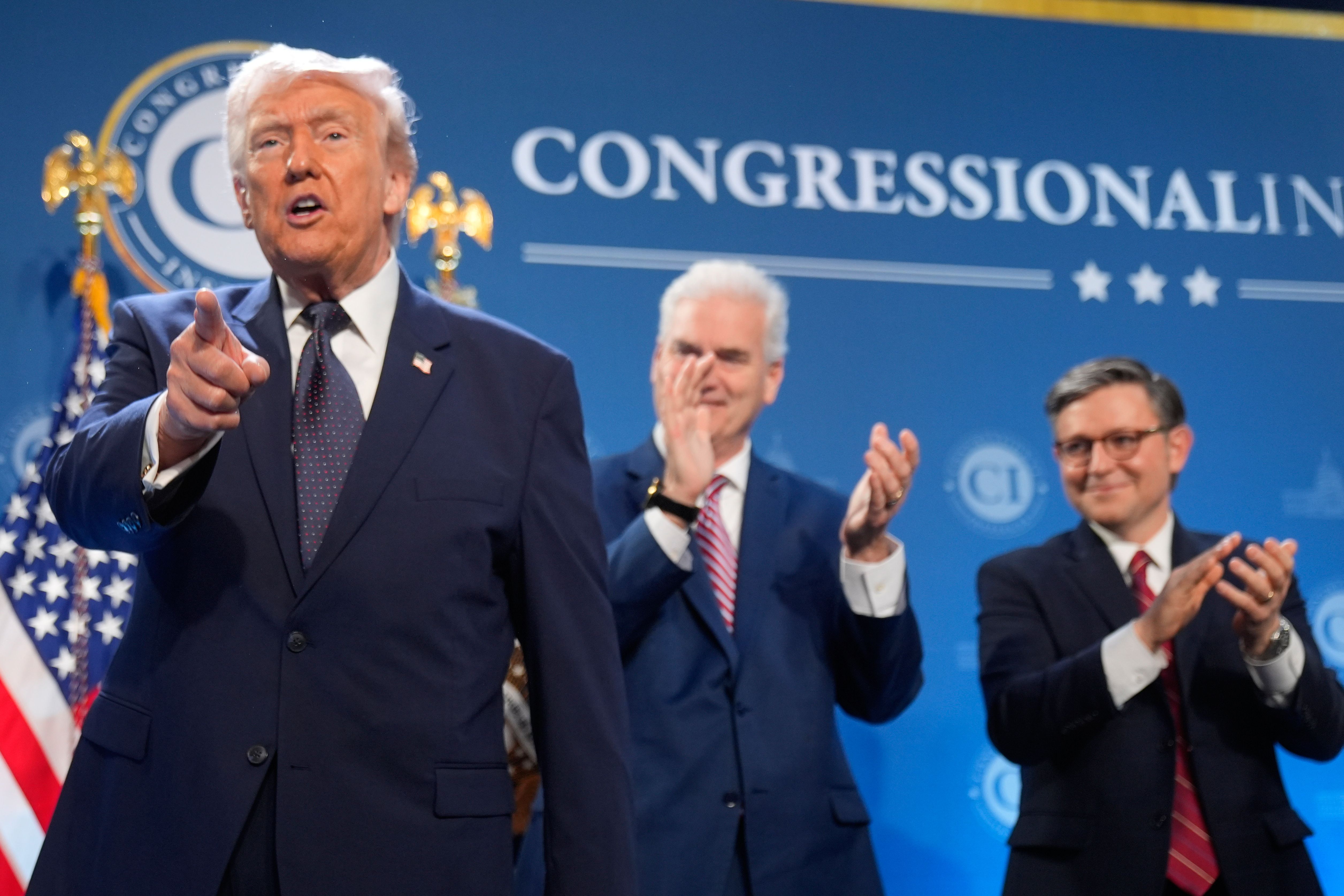 President Trump points toward the crowd at a House GOP conference in Doral, Fla., yesterday. 