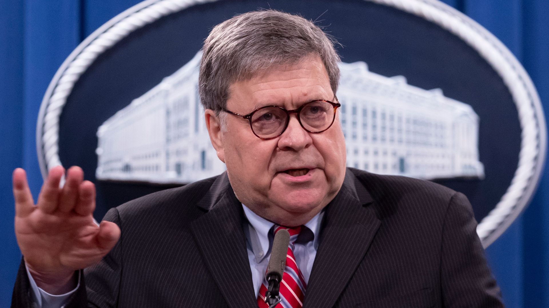 Bill Barr wears a suit