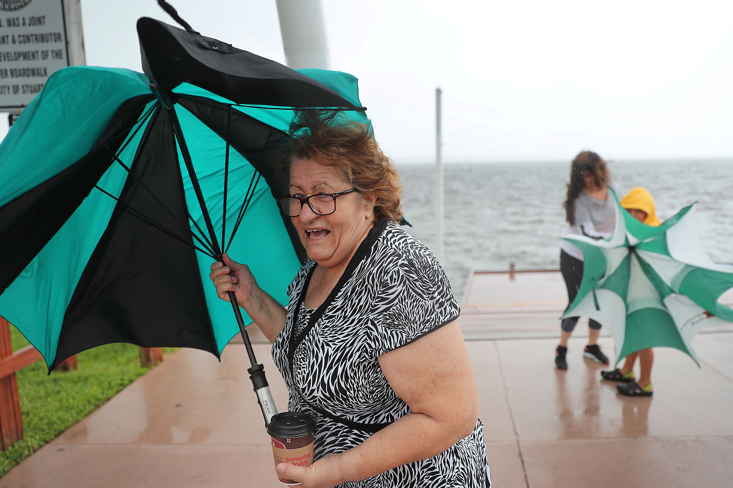 Sonya Temeloski holds her umbrella as a band of rain and wind pass over the area as Hurricane Dorian continues to make its way toward the Florida coast on September 02